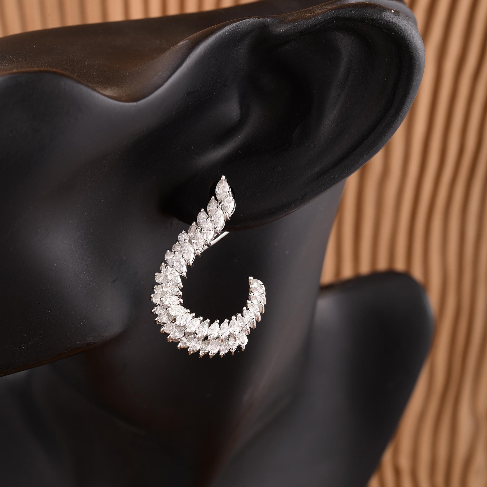 Each earring features a dazzling pear-cut diamond, renowned for its distinctive teardrop shape that exudes grace and refinement. The diamonds boast exceptional clarity, ensuring a mesmerizing sparkle that captures the eye with every movement.