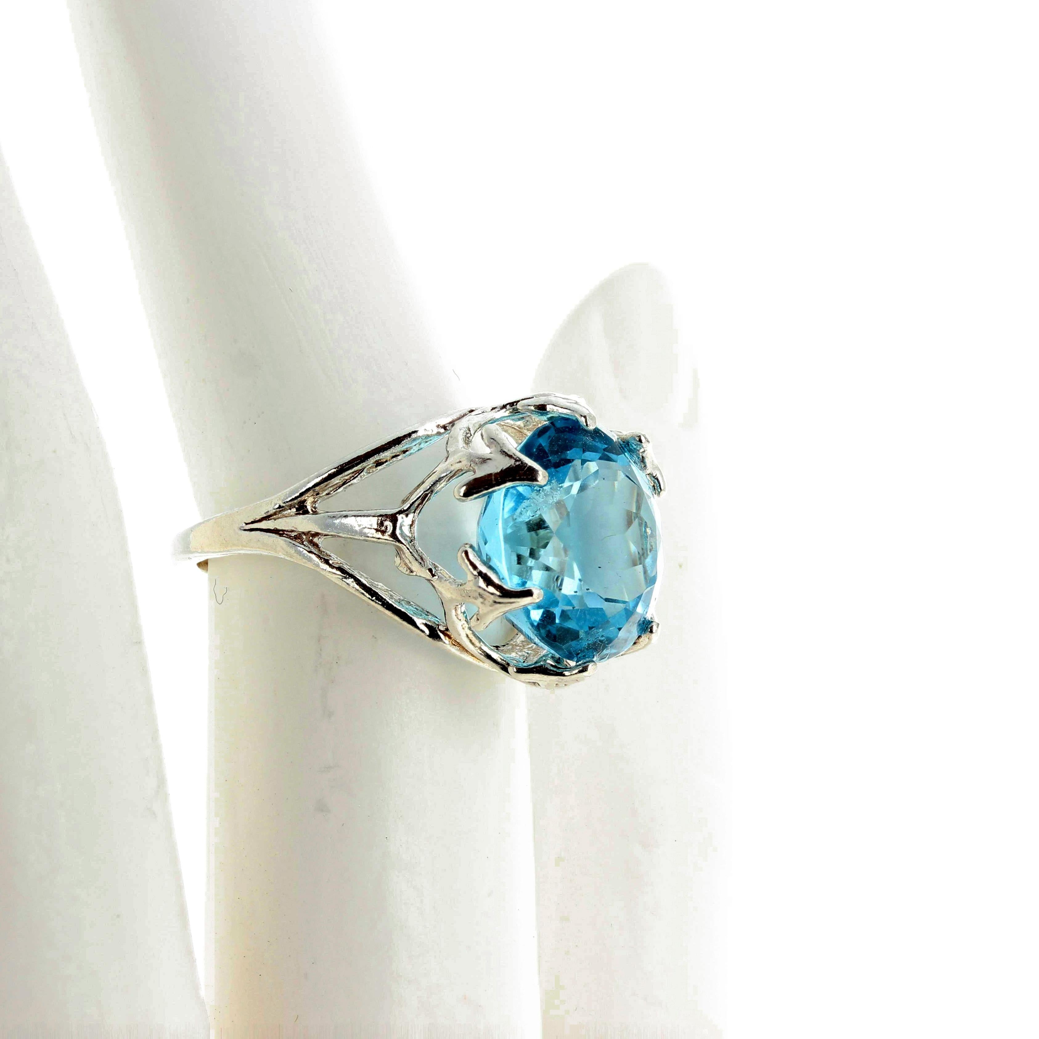 Glittering 10 Carat beautifully cut natural Sky Blue Topaz set in a unique Sterling Silver ring size 7 (sizable).  This beautiful Topaz is 13 mm and has an unusual cut to give it more sparkle. 
