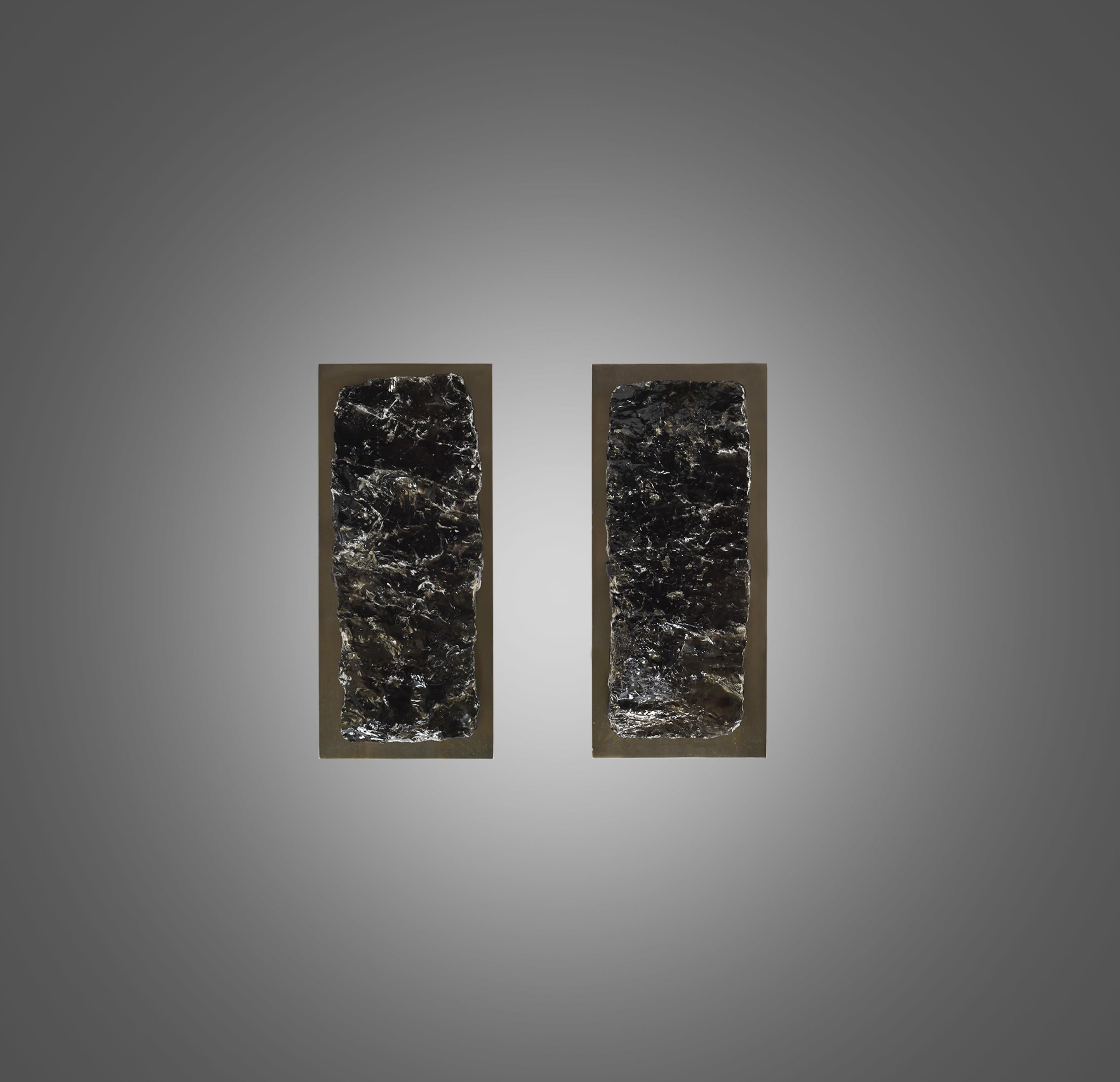 Pair of natural smoky rock crystal sconces with antique brass frames. Created by Phoenix Gallery, NYC. 
Each sconce installs 2 sockets. Use 2 led warm lights. 60 watts each light bulb, total 120 watts maximum. Lightbulb included.