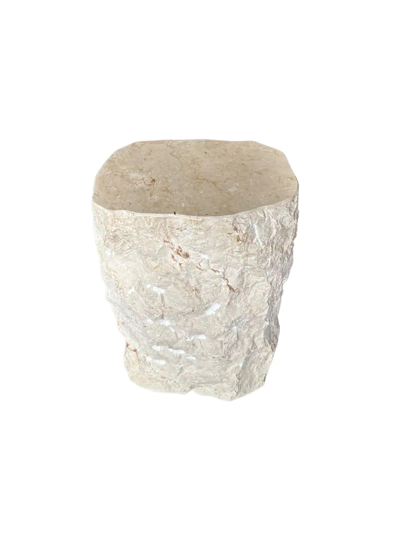 A wonderfully organic solid marble side table with a polished top and hand chiseled sides. The mix of textures and shades adds to its charm.