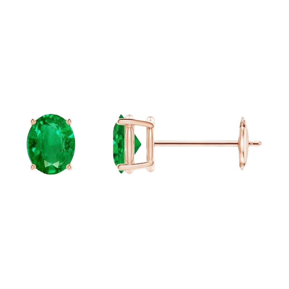 Clous d'oreilles solitaires ovales en or rose 14 carats avec émeraude de 0,60 carat