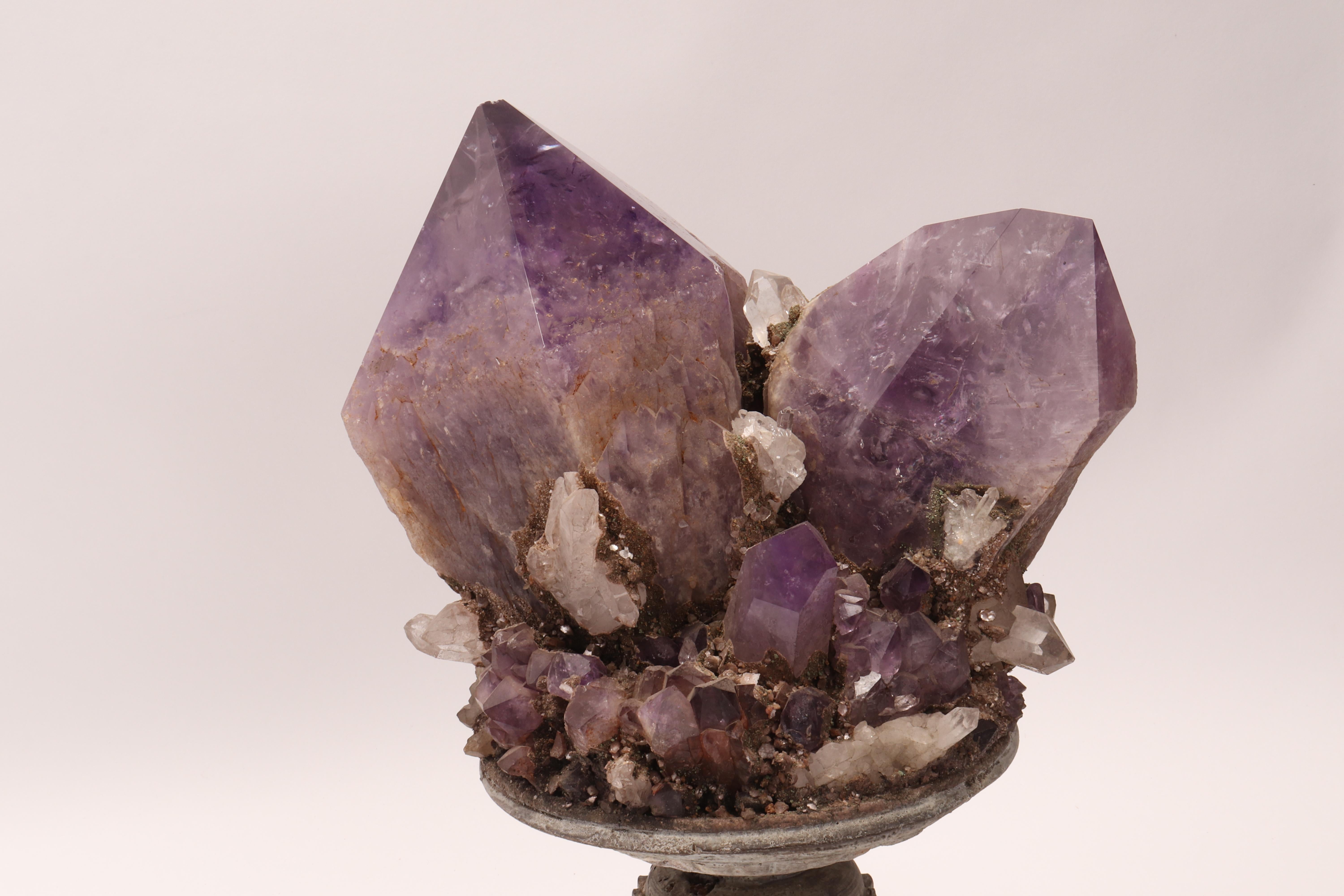 A Naturalia mineral specimen. A Druze of amethyst and quartz crystals mounted over a wooden base on a vase shape, Italy, circa 1880.