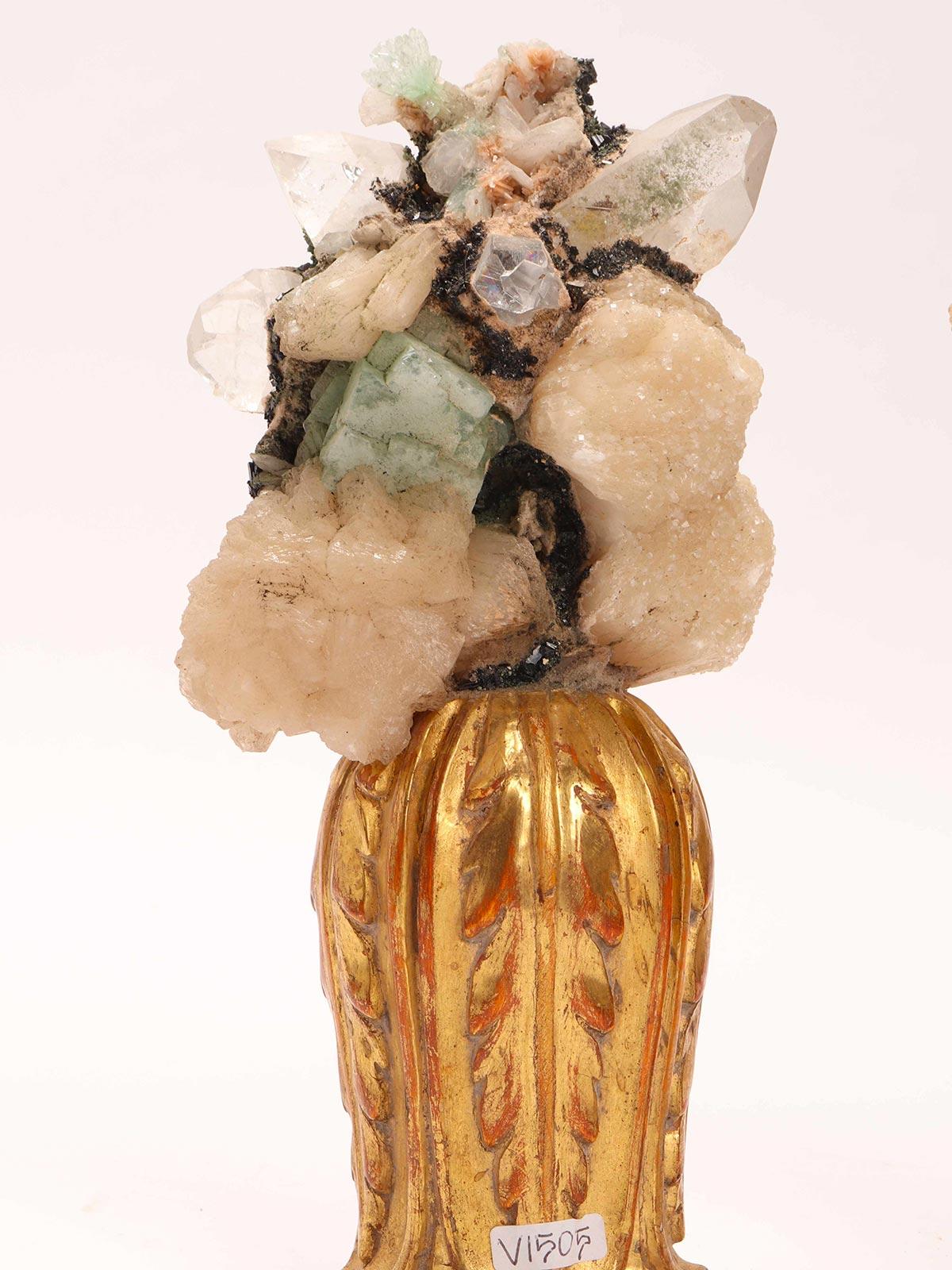 A natural mineral specimen. A pair of Apophyllite quartz Druzes mounted over a carved wooden base, vase shape with leaves gold gilt. Italy 1880 ca.