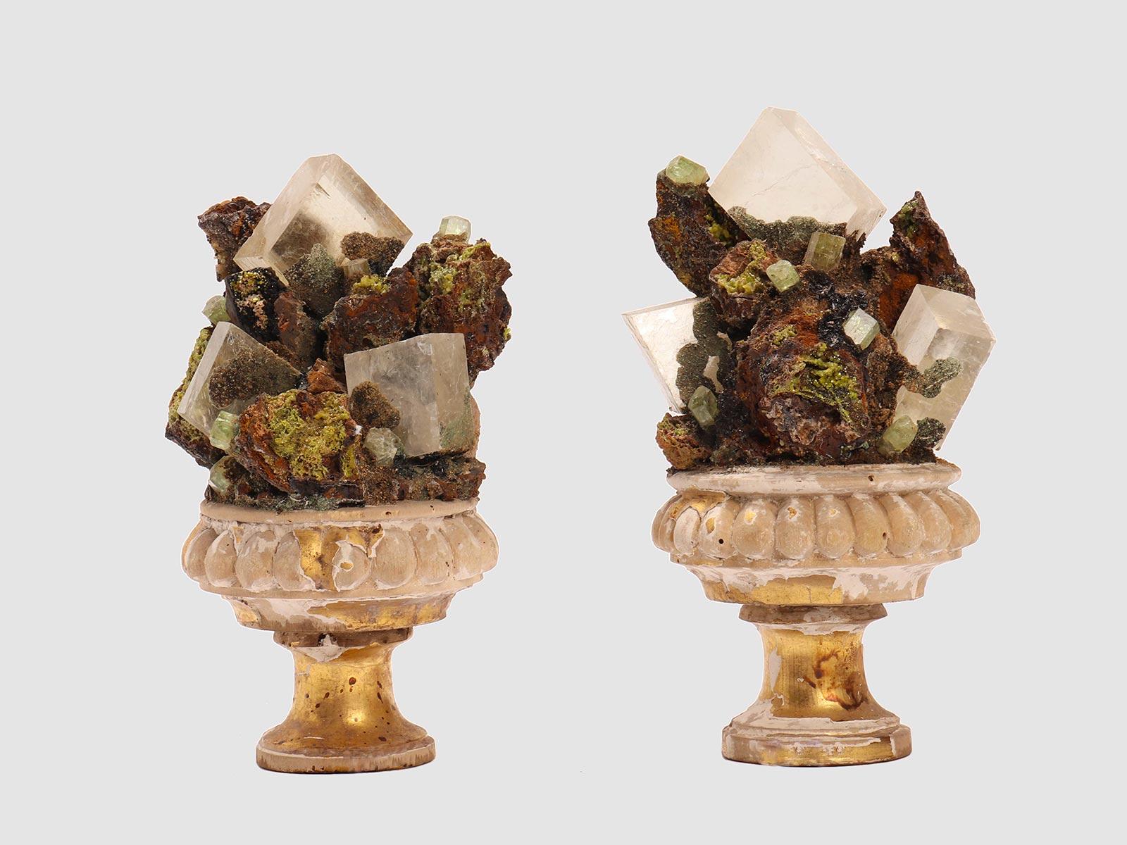 A Naturalia mineral specimen. A pair of Elbanite crystals and quartz druzes, mounted over a gold-plated wooden base vase shape, Italy, circa 1880.