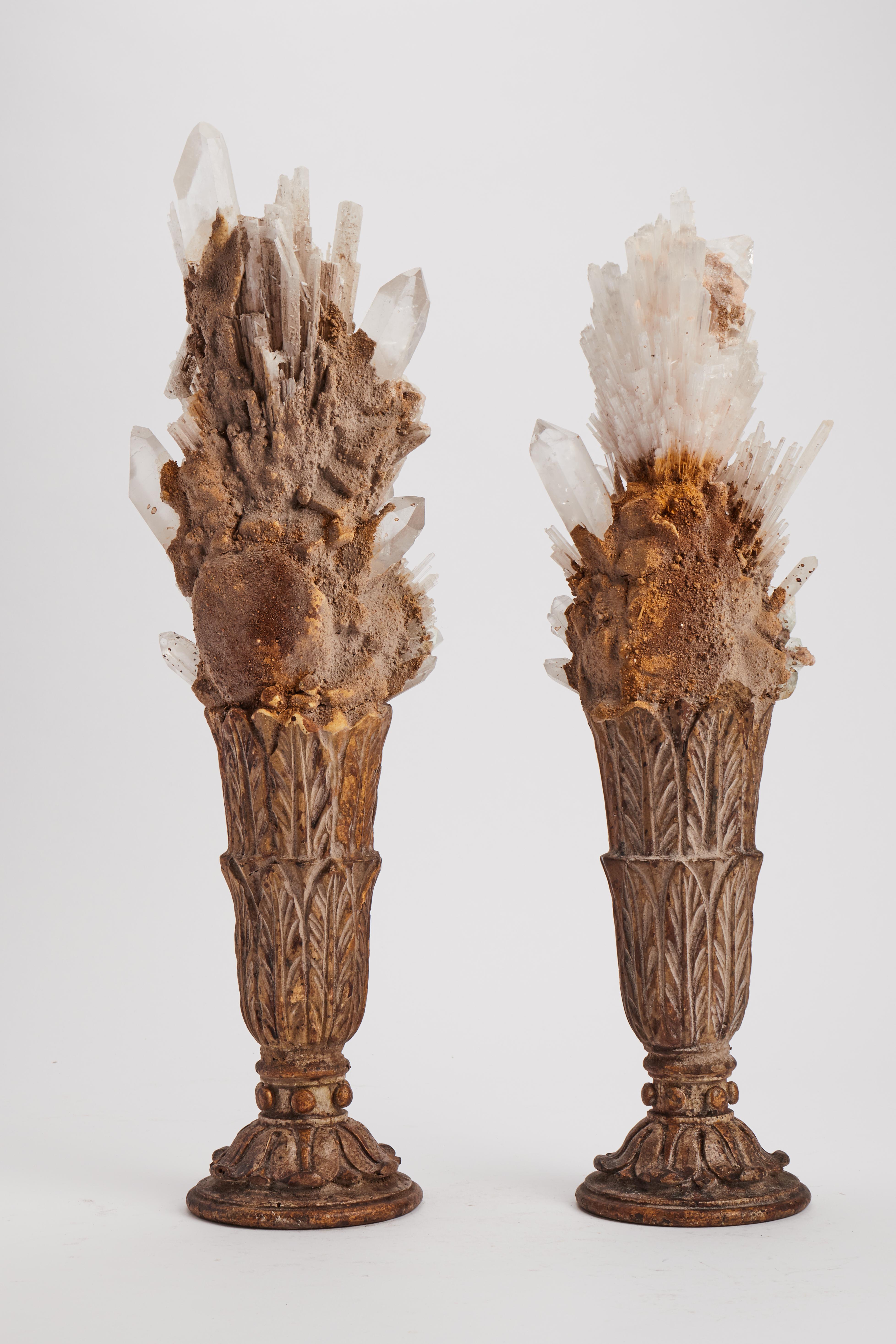 A Naturalia mineral specimen. A pair of compositions of Scolecite and Apophilite crystals, mounted over gold-plated wooden bases, shape of vase with carved leaves. Italy 1880 ca.