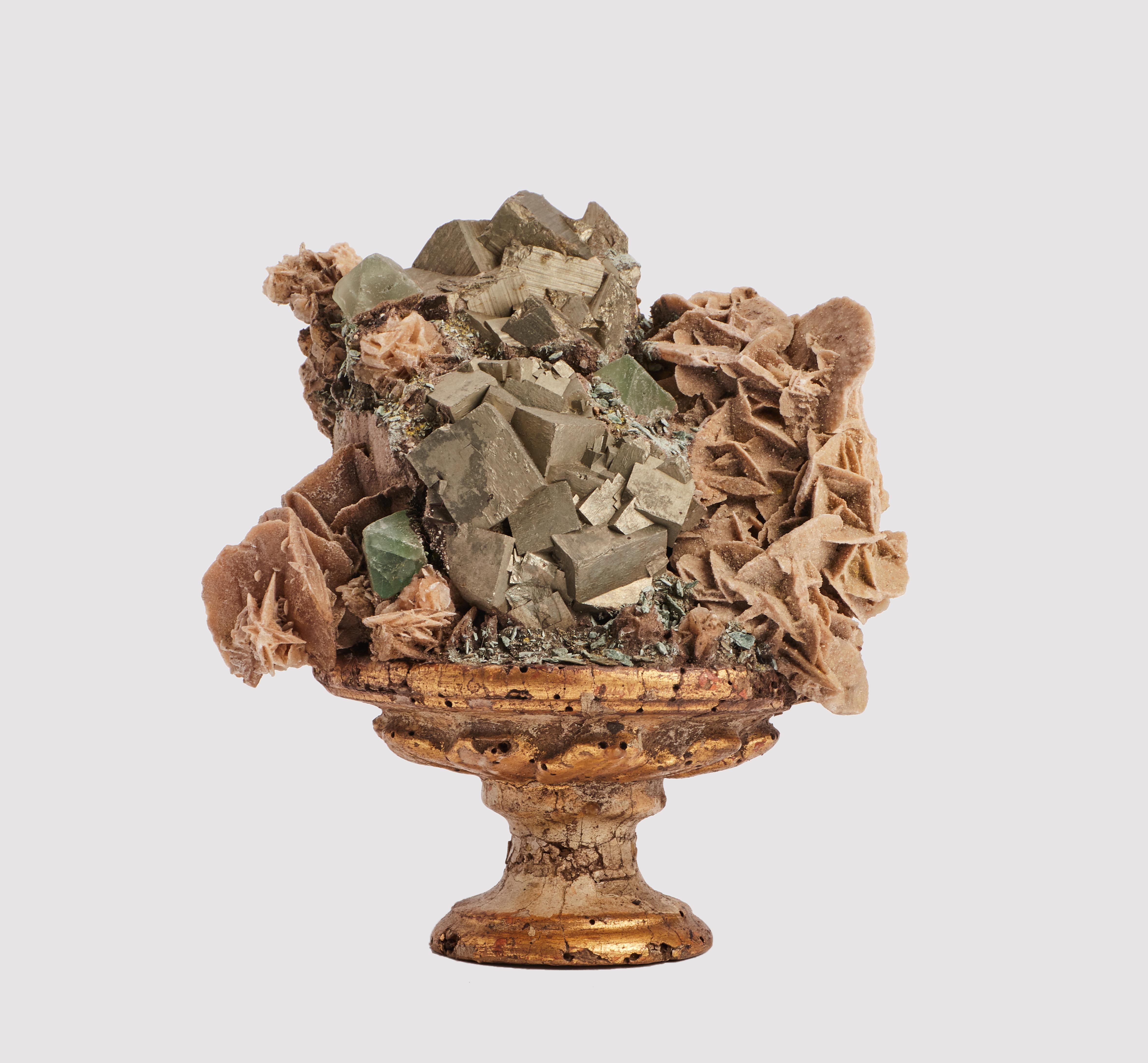 A Naturalia mineral specimen. A fluorite crystals and cubic pyrite cristals mounted over a guild-plated and lacquered wooden base with leaves decoration. Italy, around 1880.
