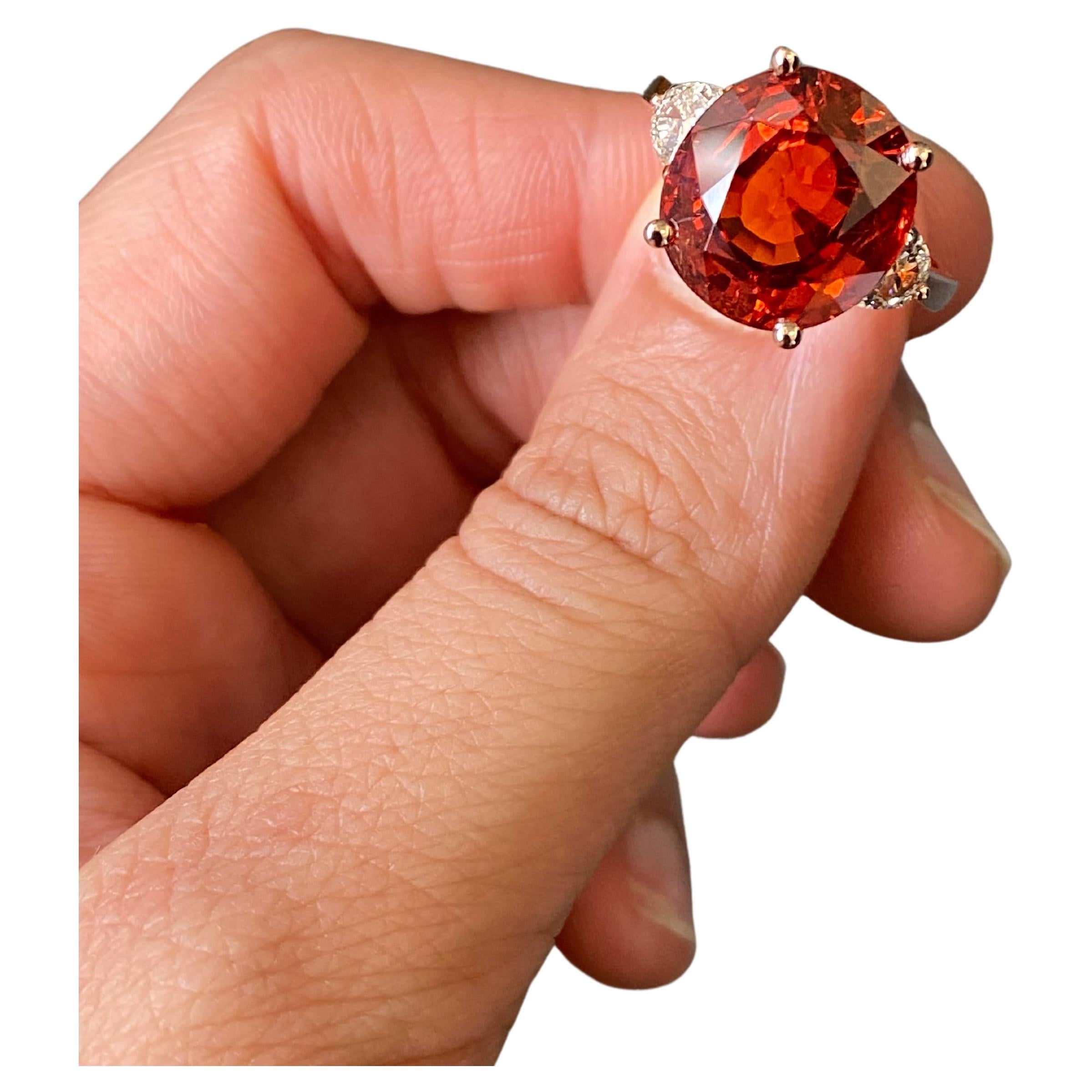 Ring Details :
Spessartine: 11.5 carat
Diamond: 0.42 carat
18K Gold Weight: 5.78 grams

Please feel free to message us for more information, the ring comes with a certificate from an independent gem lab. We will happily accept returns, and provide