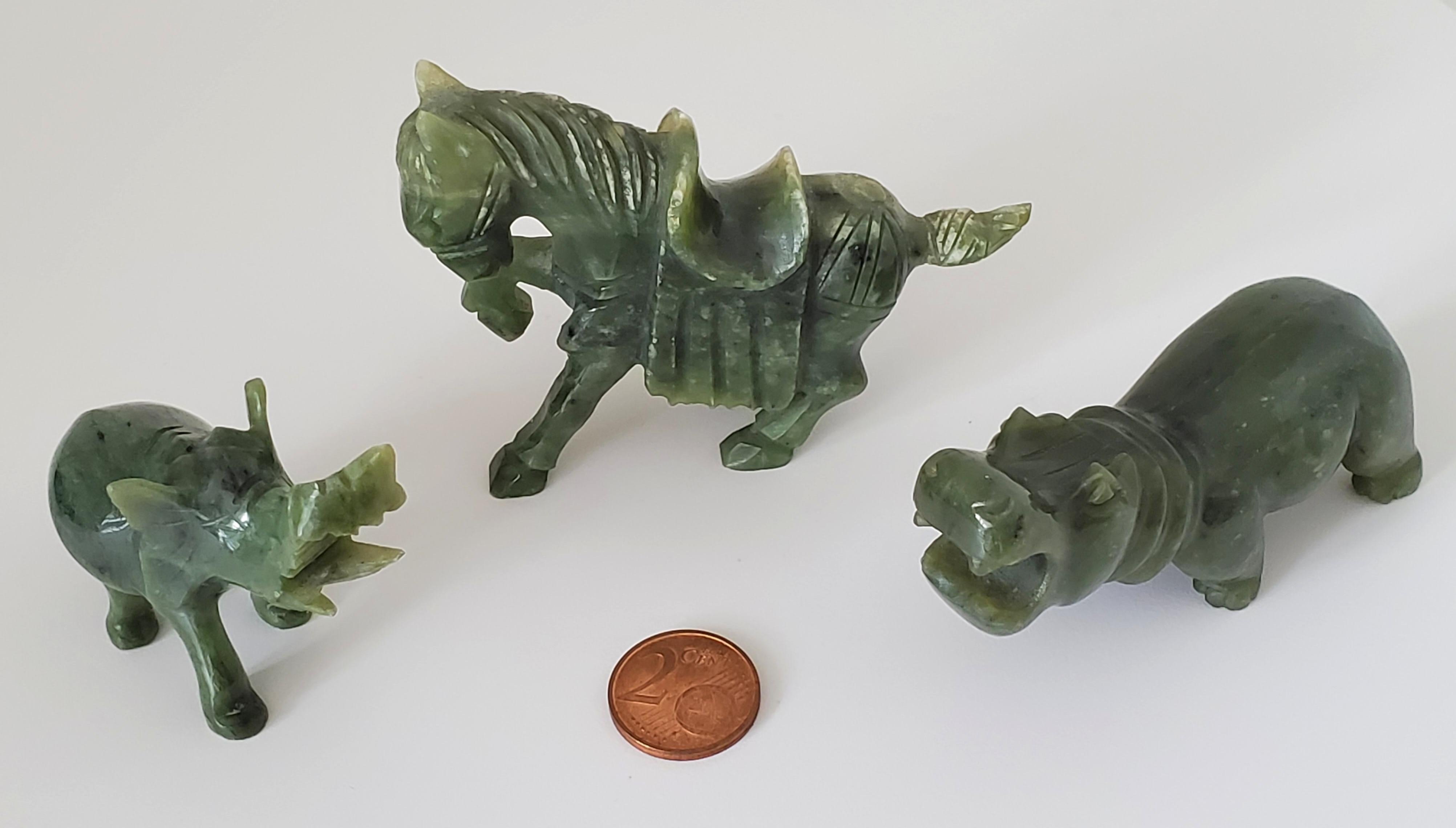 These lovely spinach jade animal figures consist of a Tang horse, an elephant, and a hippo. The largest is the Tang horse at 8cm x 6cm x 2.2cm, and the smallest is the elephant at 6.2cm x 5.2cm x 2.2cm. These animal figures were purchased from a