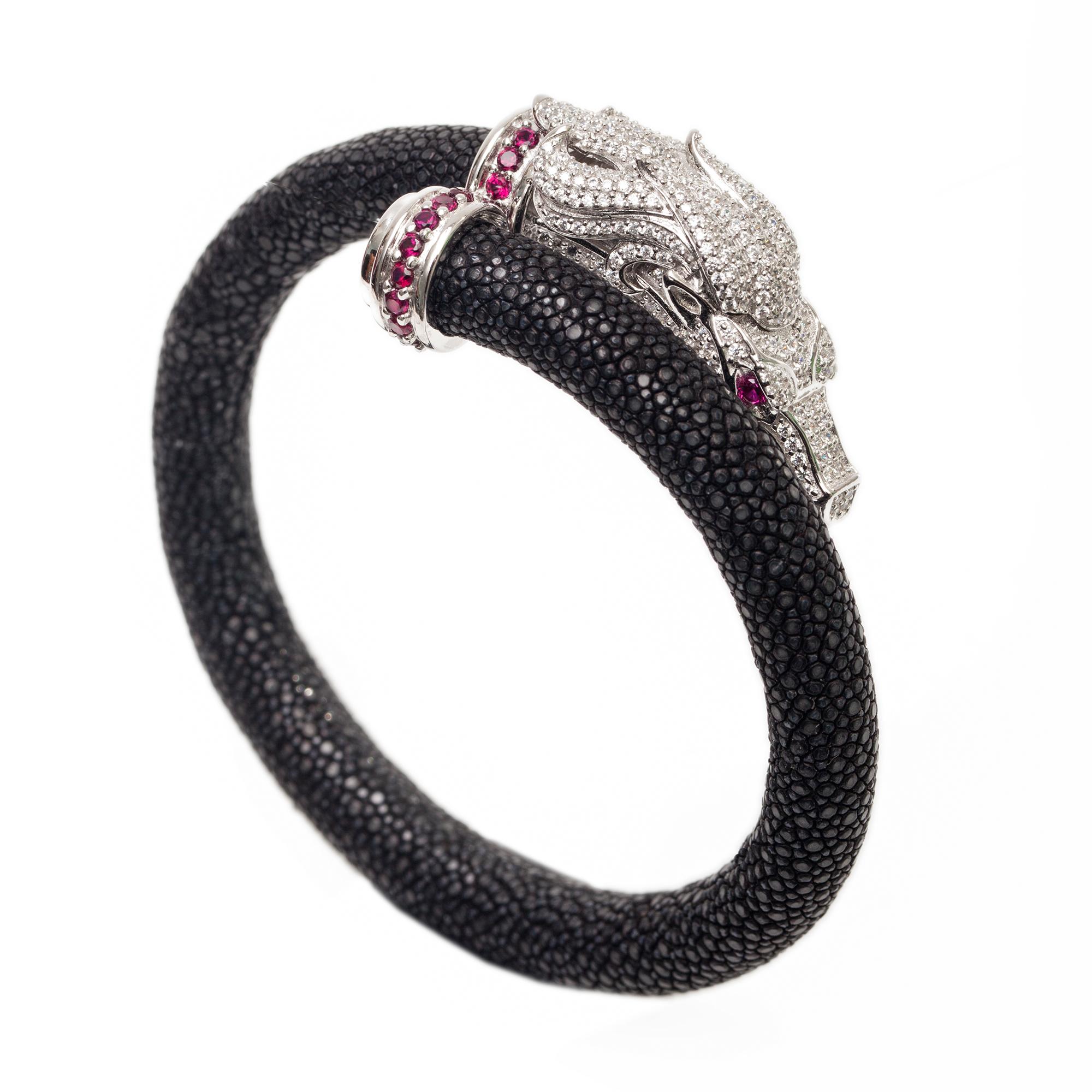 A perfect gift for all hose lovers. This bracelet is a Beautiful design masterfully sculpted from platinum and rhodium plated sterling silver and natural stingray leather. The horse head is hand set with high grade clear and red cubic zircon.  A