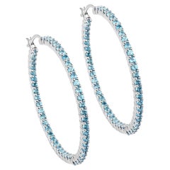 Créoles en argent rhodié avec topaze bleue naturelle suisse d'un total de 3,60 carats