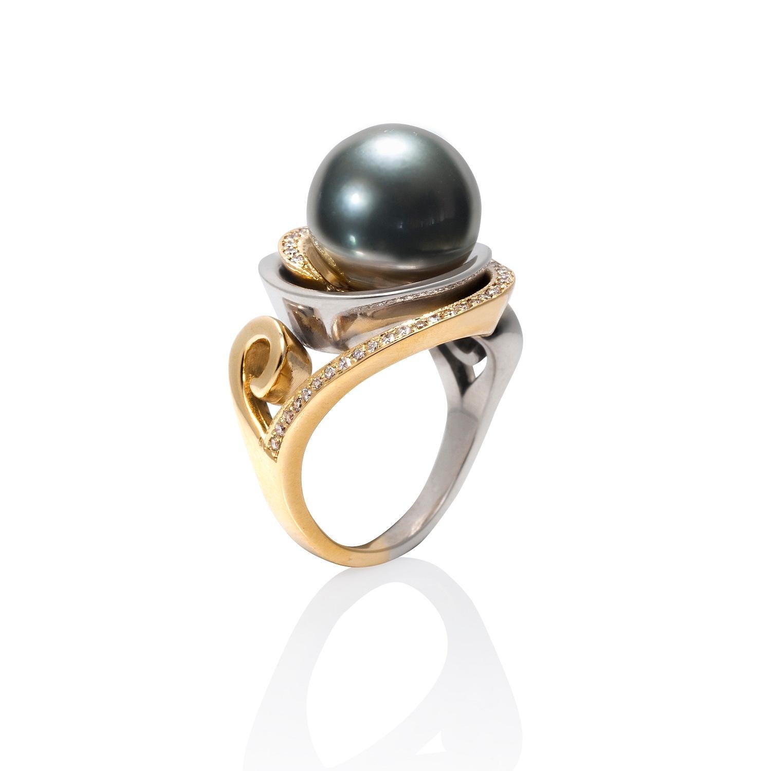 The Nebula Cocktail Ring with the 12mm natural Black Tahitian pearl is a ring with interlocking spirals of 14ky and argentium sterling silver that wrap around the pearl. The 14k spiral is pave set with sixty-eight 0.8mm VS2-SI1 diamonds.

This ring