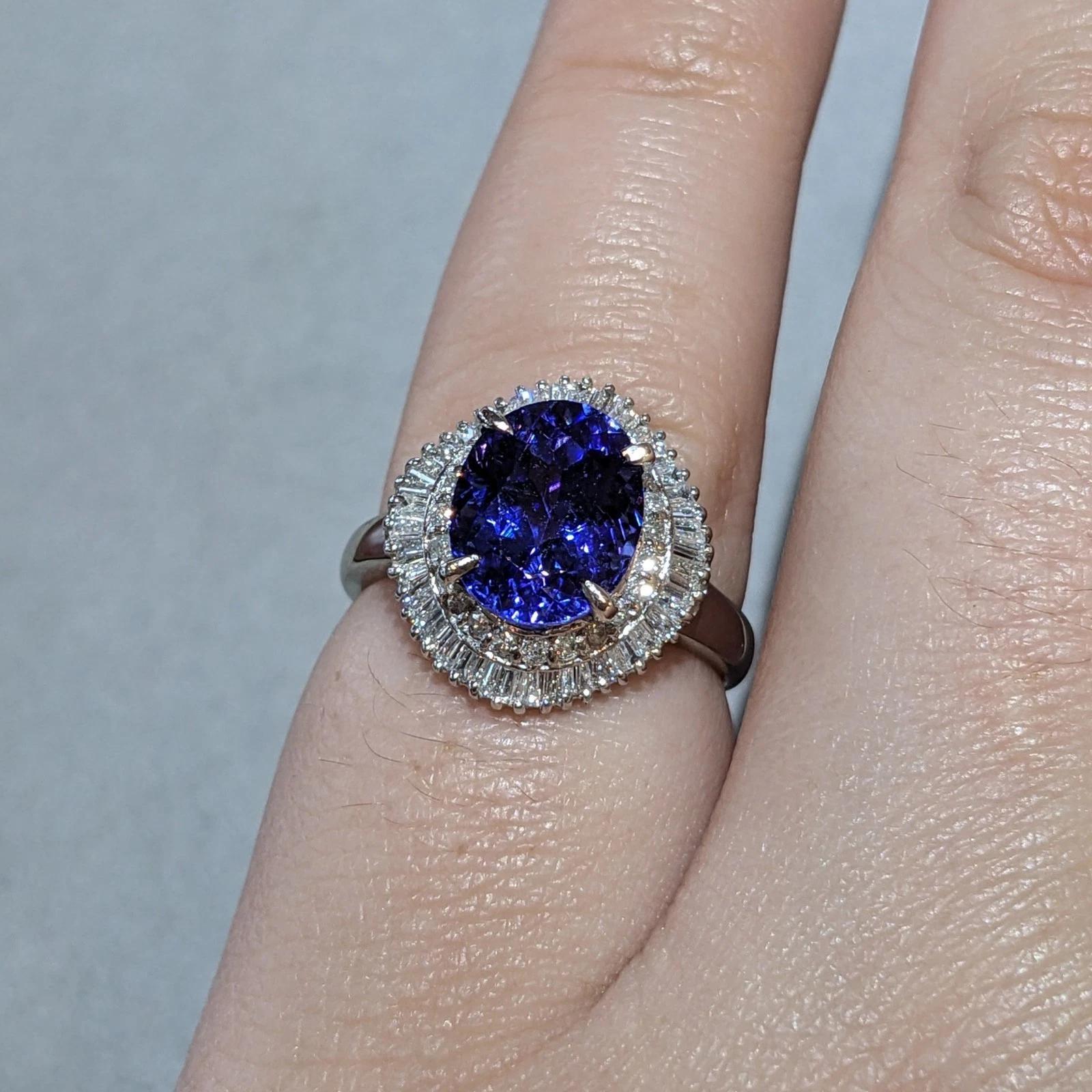 Natural Oval Tanzanite & Diamond Ballerina Setting in Platinum 

Tanzanite and Diamond Ring features a Natural Oval Tanzanite weighing 3.96 carats accented by Natural Round Brilliant and Baguette Diamonds, all set in a Platinum ballerina