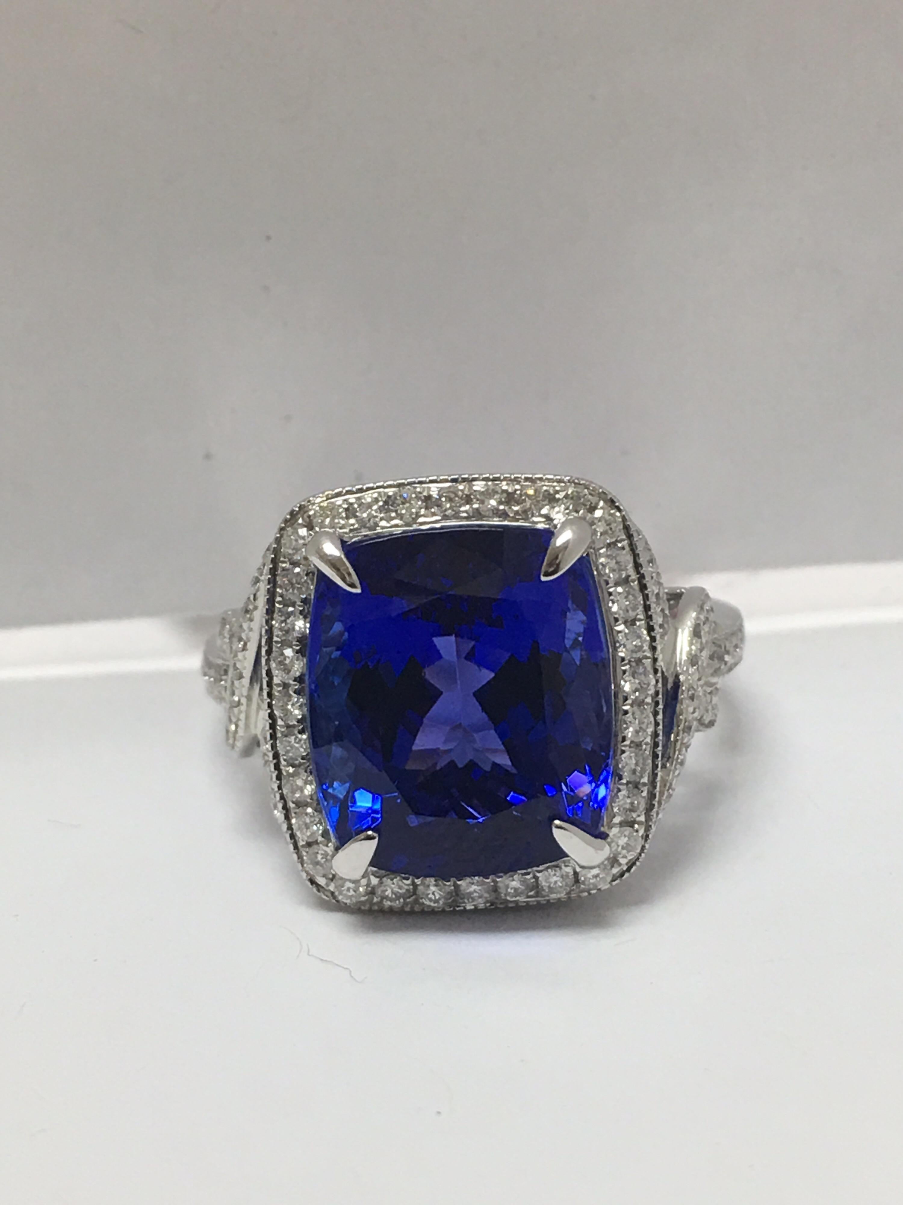 Natural cushion cut Tanzanite 8.34 Carat and 0.51 Carat round white  Diamond Set In 14 Karat gold. The ring is handcrafted and one of a kind. This is AJI Certified and size is 7 if needed the ring can be resized.