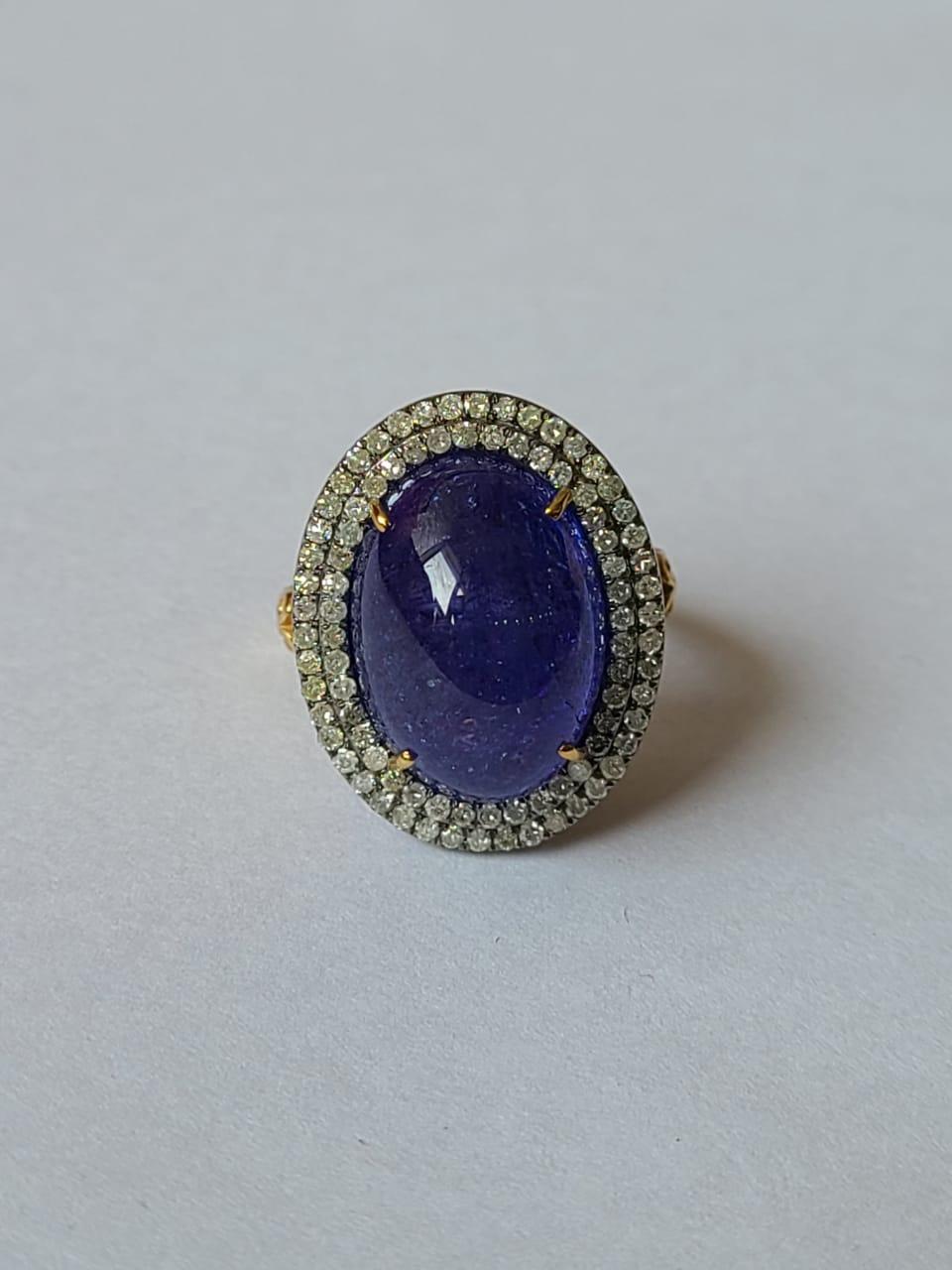 A very gorgeous and one of a kind, Tanzanite Art Deco Style Victorian Cocktail / Dome Ring set in 14K Gold, 925 Silver & Diamonds. The weight of the Tanzanite Cabochon is 13.06 carats. The Tanzanite is responsibly sourced from Tanzania. The weight