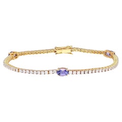 Natural tanzanite & diamond tennis bracelet in 18k gold