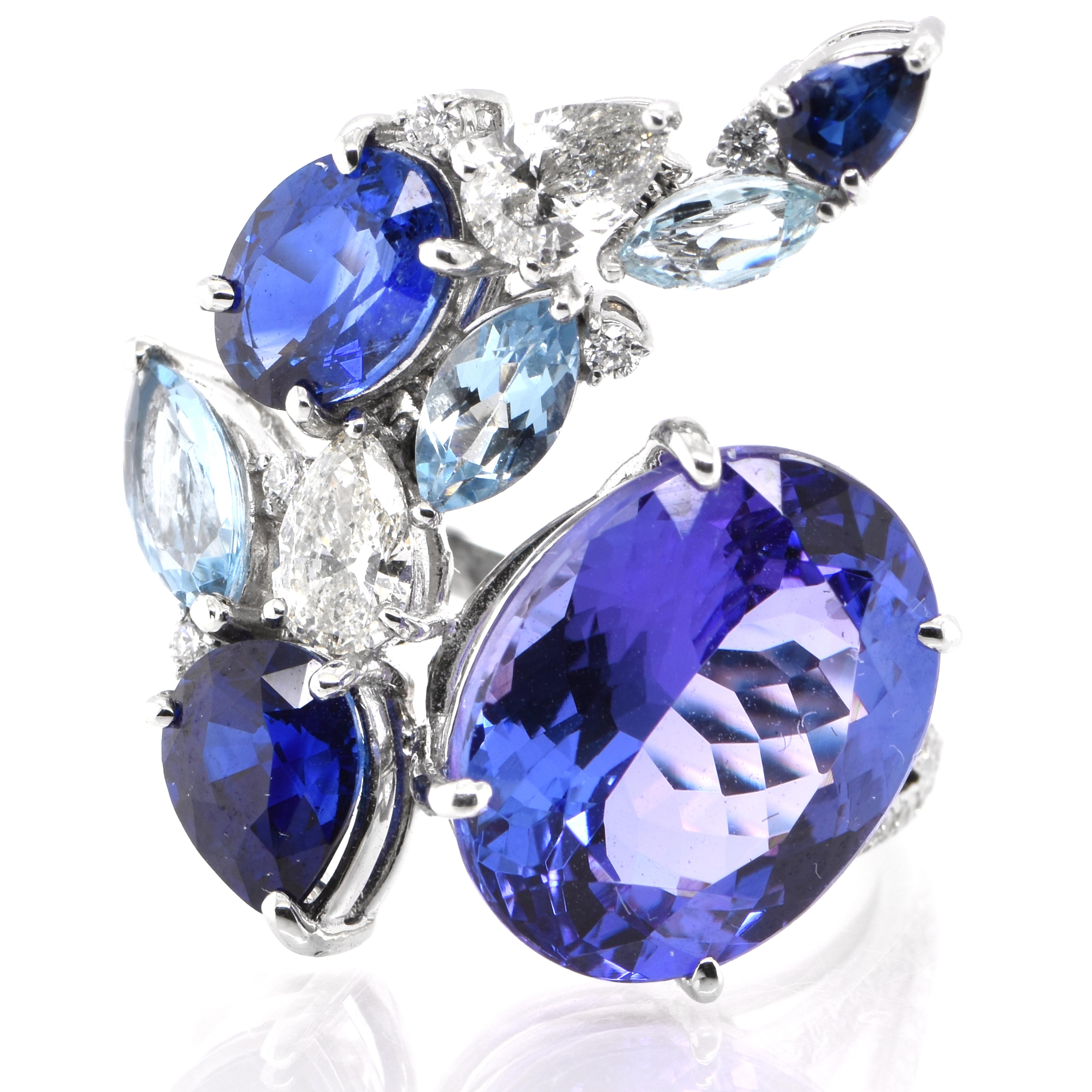 A beautiful Cocktail Ring featuring 6.31 Carat Natural Tanzanite, 2.12 Carats Natural Sapphires (Certified by AIGS), 0.62 Carats Aquamarine and 0.62 Carats of Diamond set in Platinum. Tanzanite's name was given by Tiffany and Co after its only known