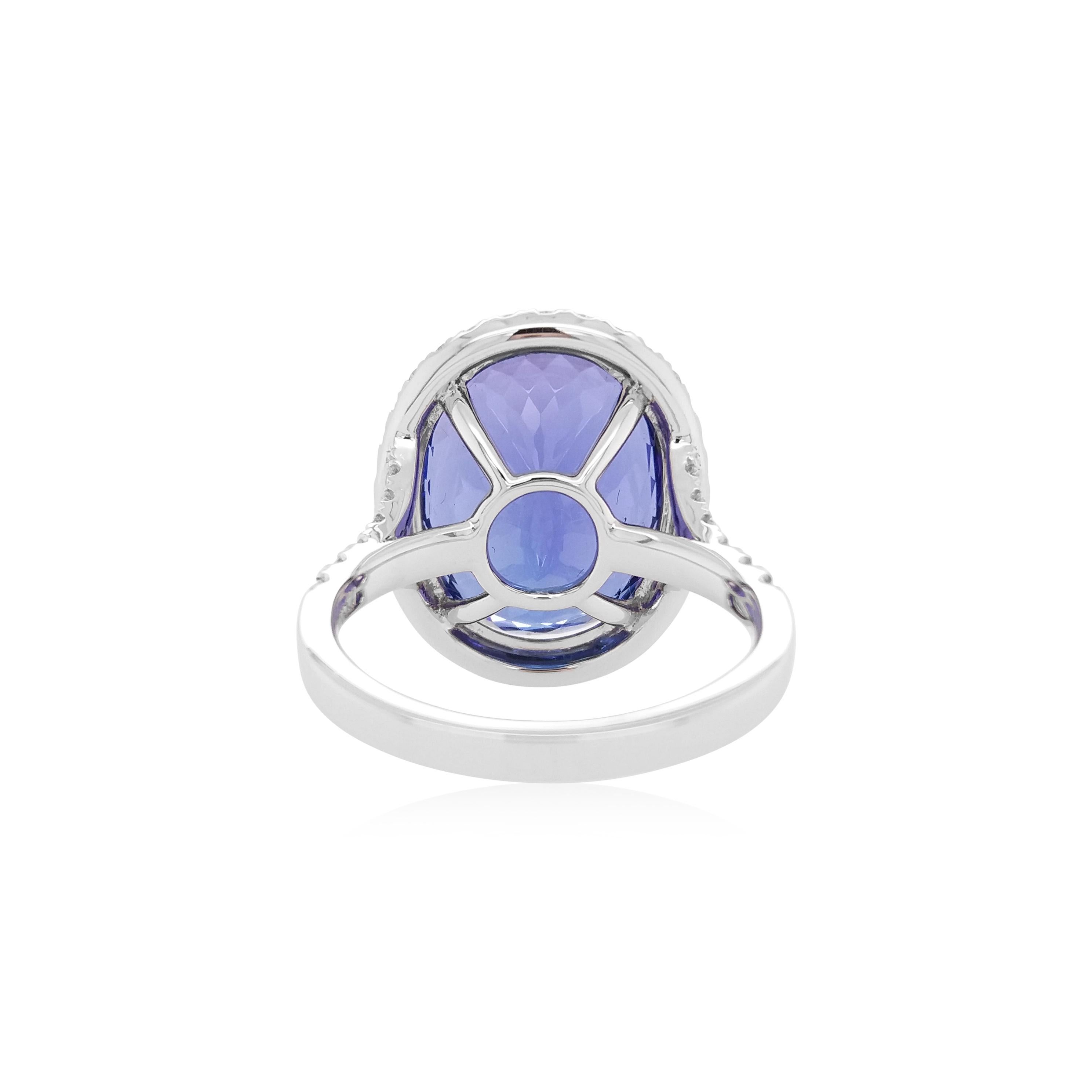 This mesmeric platinum ring features spectacular natural Tanzanite at its forefront, accentuated by a halo of glistening white diamonds which surrounds it. Bold, yet intricate, this one-of-a-kind ring will add a sumptuous touch of colour to your