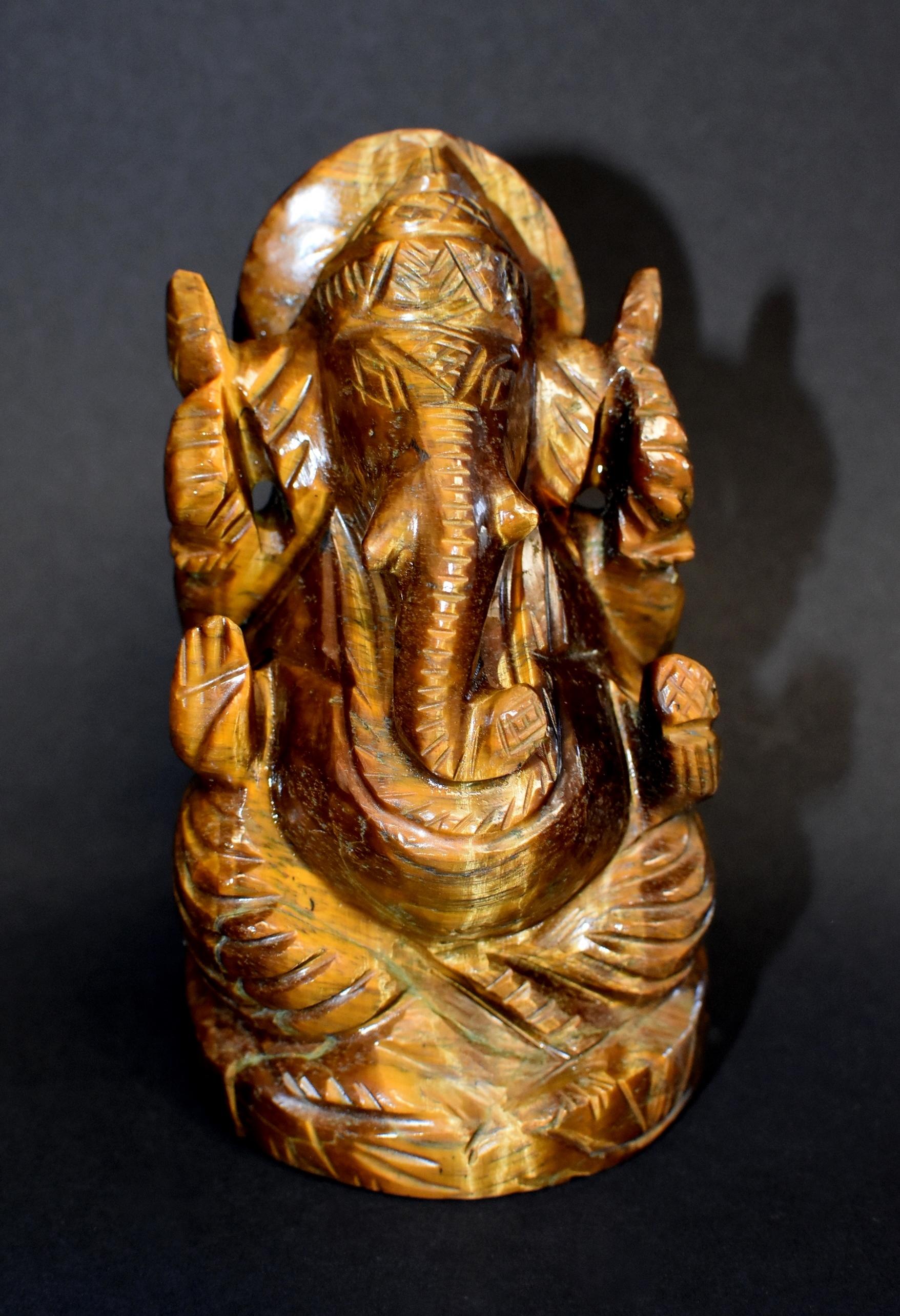 A beautiful natural tiger's eye sculpture depicting the ganesh. This entire sculpture is made of one piece of the finest quality tiger's eye that weights 1 lb with fantastic iridescence. One of a kind. Tiger's eye is believed to enable clear vision