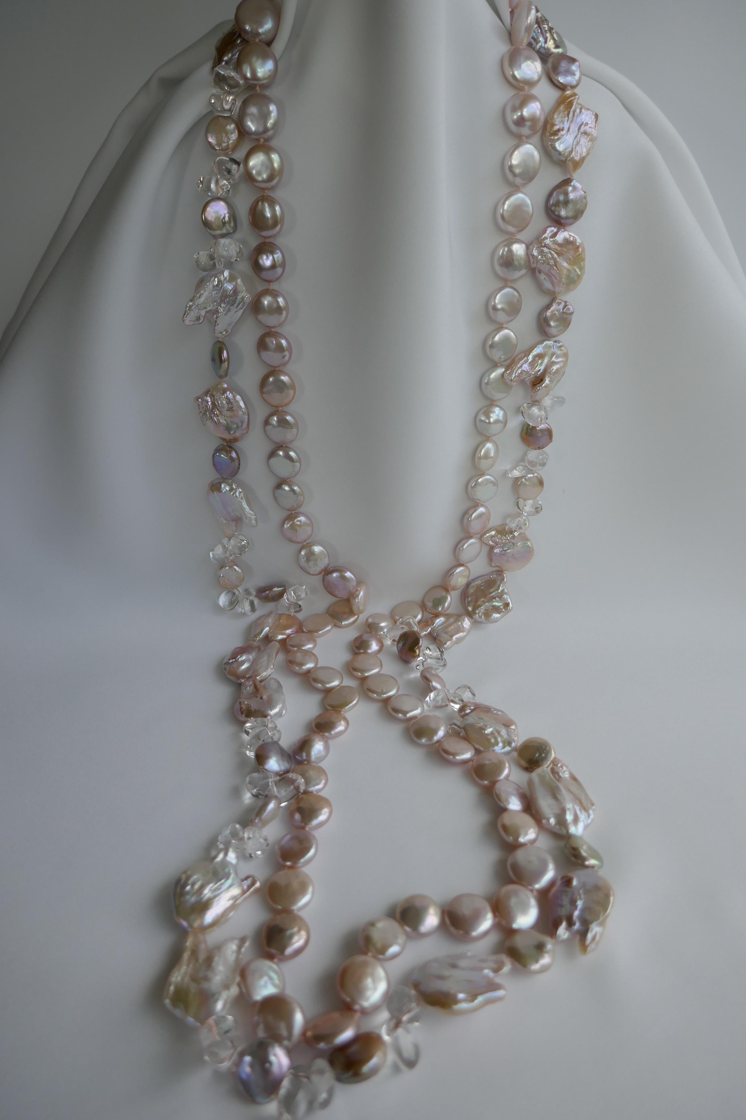 These are two long natural keshi cultured pearl necklaces. Extremely wearable and versatile. One necklace is a natural pale tone pinky lavender coin shaped pearl necklace that may also be worn alone. The keshi coin pearls are 14-15mm. The color and