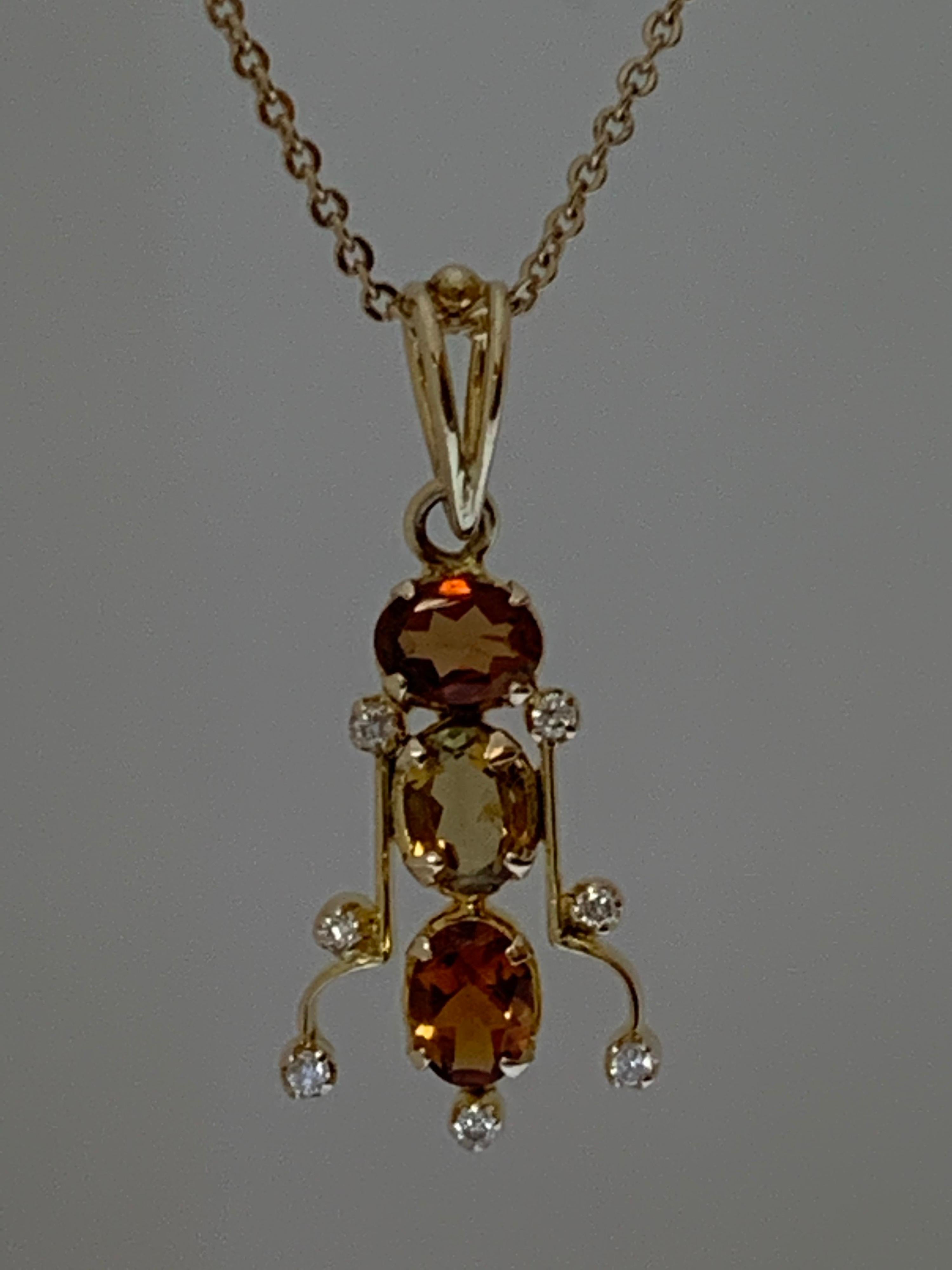 Natural 3 mm X 5 mm Tourmaline  ( 3 pcs ) and White Round diamonds set in 14 Karat Gold is one of a kind handcrafted Pendant. The stones are not treated or heated, the stone are hand cut and polished, 