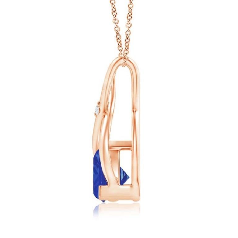 Two lustrous metal strips intersect to form an ornate wishbone bale and are accentuated with a dazzling diamond accent in the center. The wishbone connects to the trillion tanzanite in V prong setting. Designed in 18k rose gold, this bluish-violet