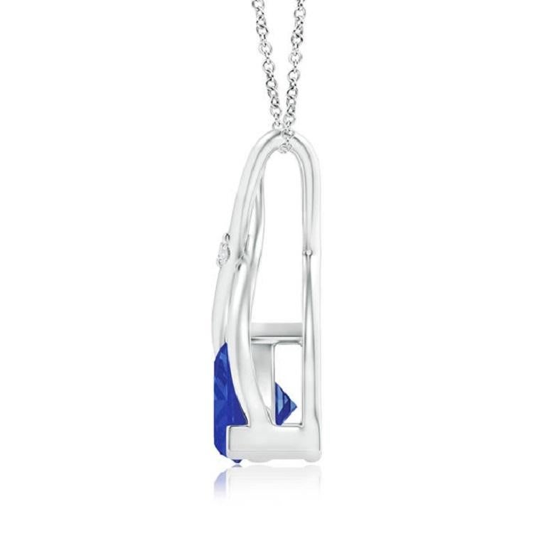Two lustrous metal strips intersect to form an ornate wishbone bale and are accentuated with a dazzling diamond accent in the center. The wishbone connects to the trillion tanzanite in V prong setting. Designed in 18k white gold, this bluish-violet