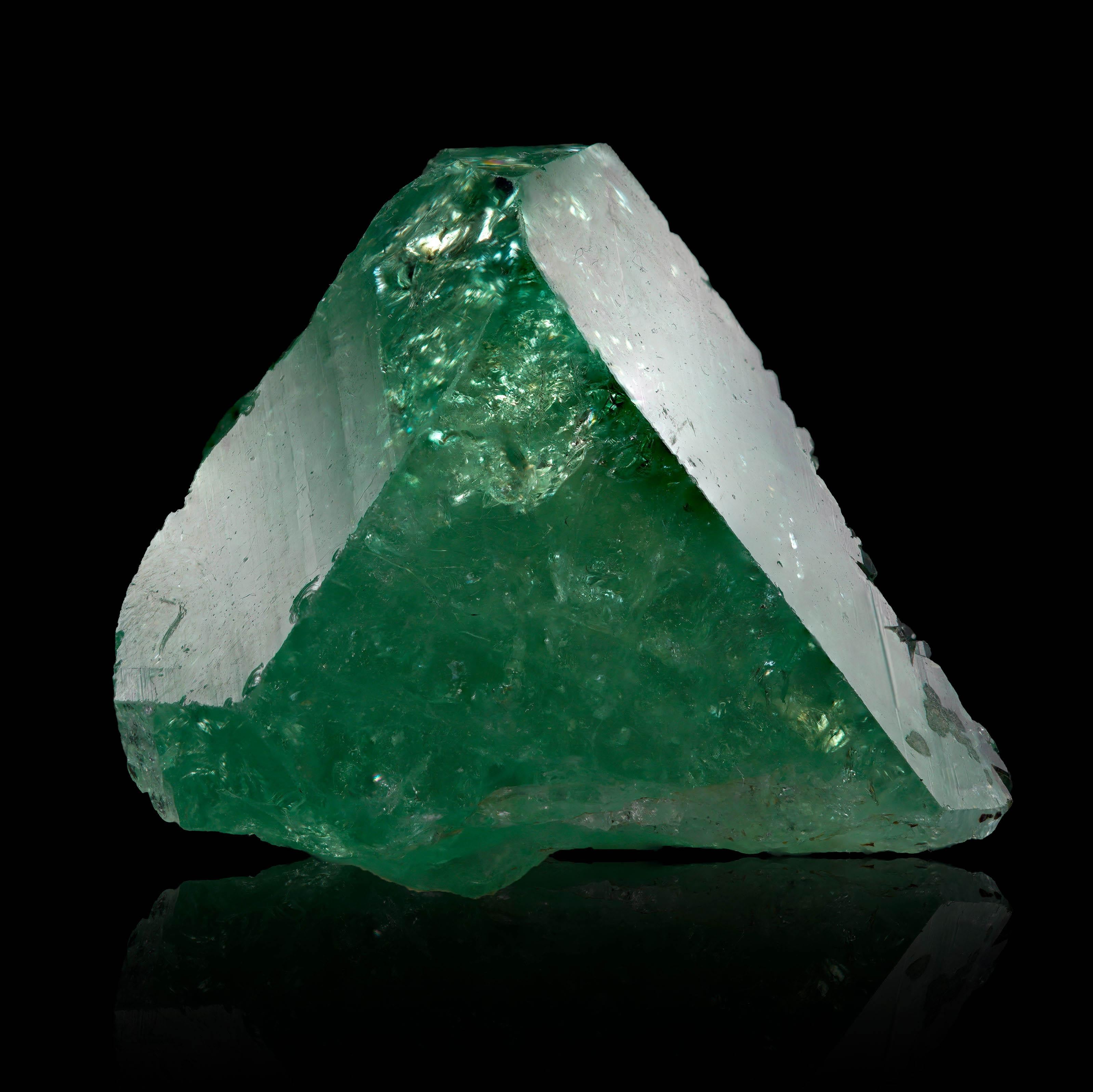 This natural tsavorite crystal is a museum-grade example of one of the rarest and most coveted members of the garnet family. Sourced from the famed Merelani Hills in the Manyara Region of Tanzania, this gem-quality grossular garnet features a rich,