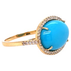 Bague en or jaune ornée d'une turquoise naturelle '5.25ct' et d'un diamant