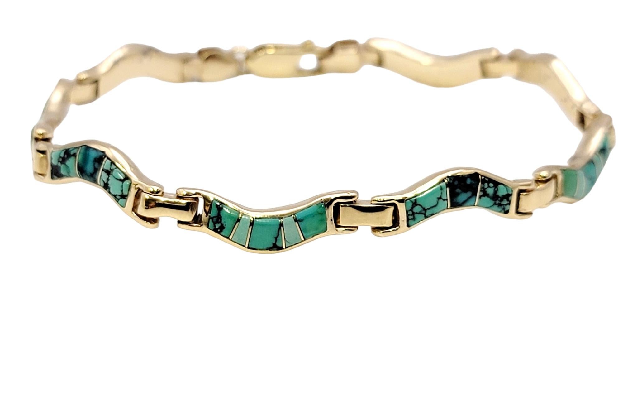 Indulge in the elegance of this captivating lady's turquoise inlay bracelet, meticulously crafted in lustrous 14 karat yellow gold in a wavy design. This stunning piece harmoniously combines the brilliance of precious metal with the vibrant allure