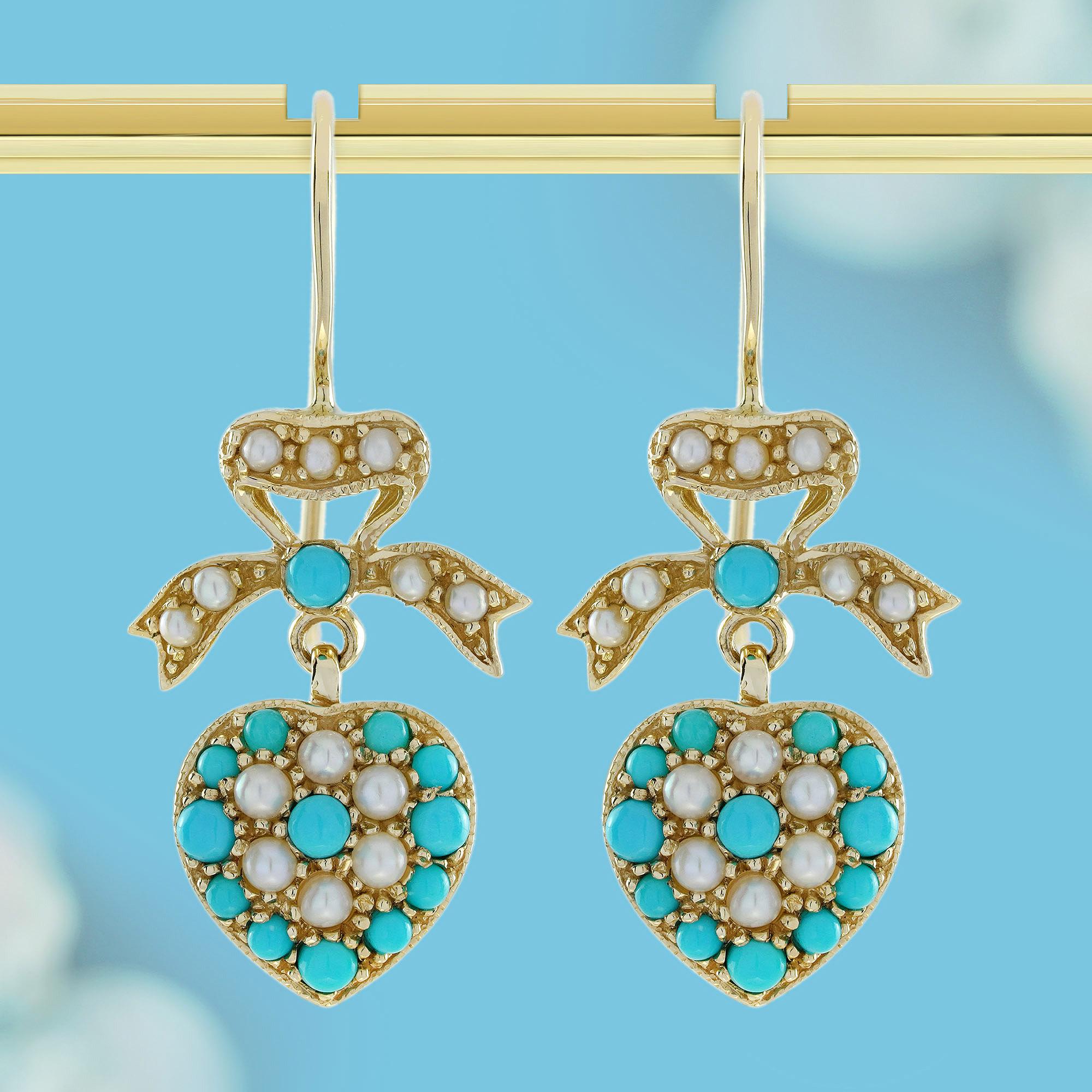 Each earring is adorned with blue turquoise and white pearls, boasting a heart-shaped design symbolizing love and affection. Adorning the top of each heart is a bow encrusted with white pearls, all set in yellow gold to provide a classic and