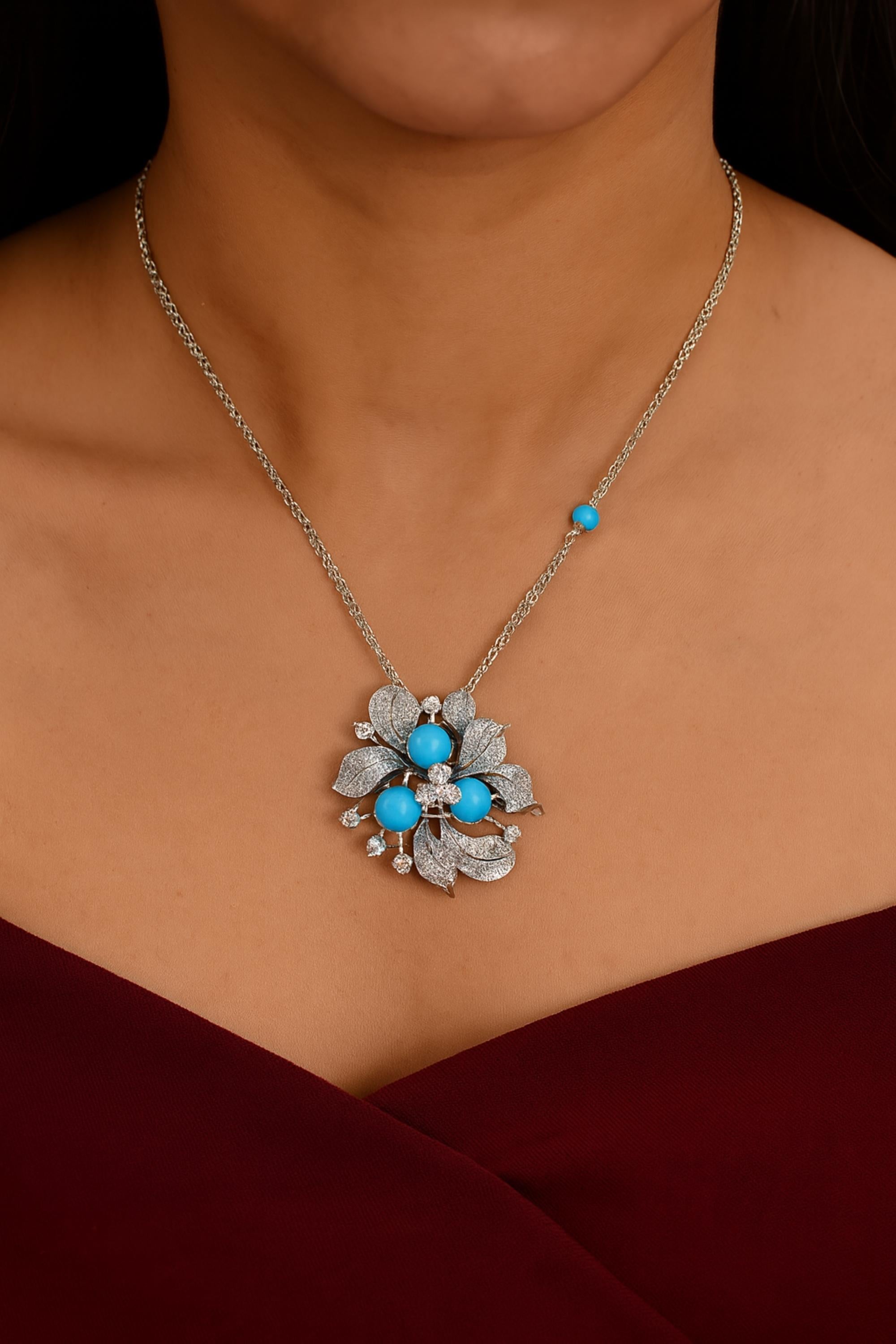 This Natural Turquoise SI/H Pave Diamond Floral 18 Karat White Gold Pendant Necklace features diamond pave set in flower petals and three turquoise gemstone set in the center of the flower and also in the chain at a distance making a beautiful