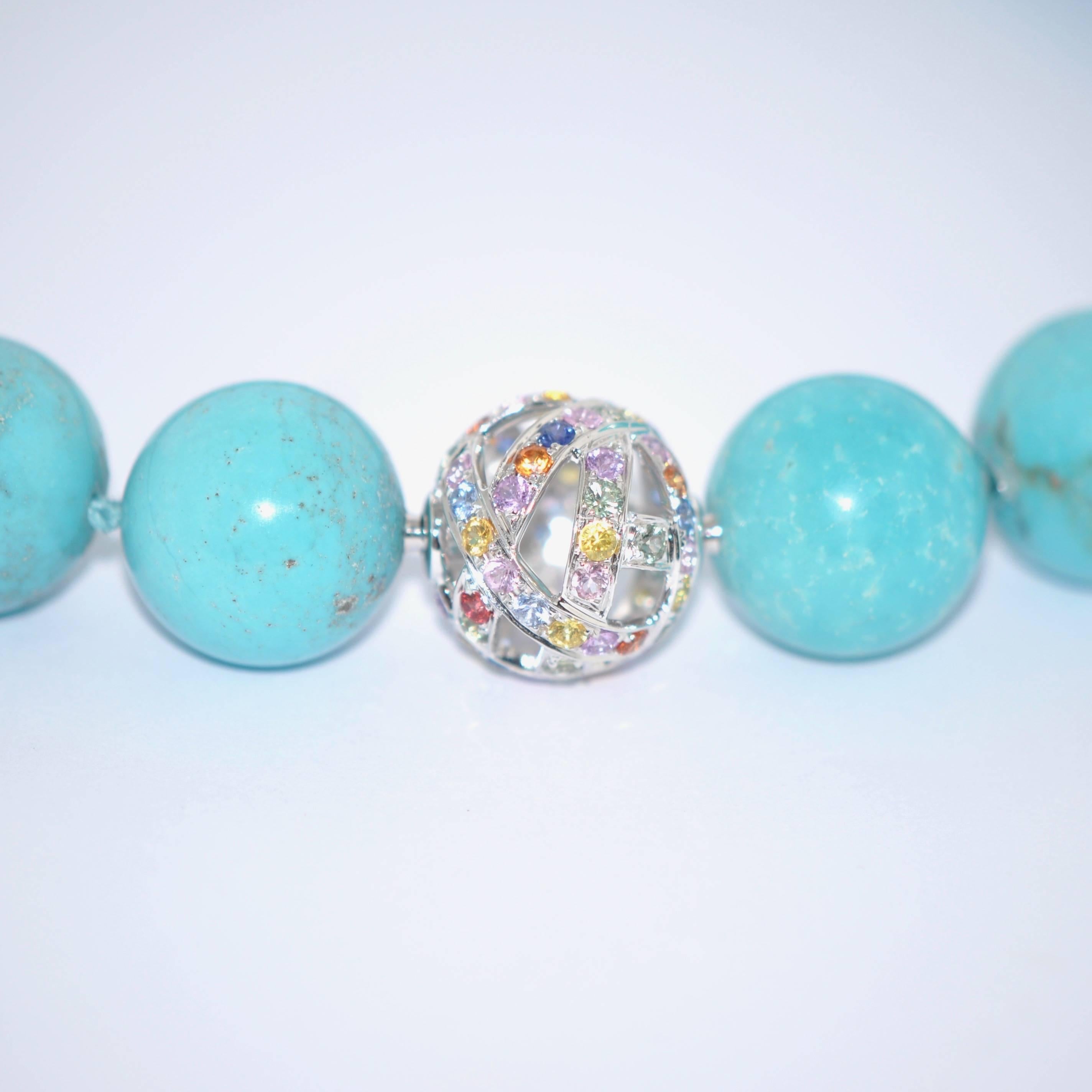 Discover this Natural Turquoises and White Gold 18K Colorful Sapphires Clasp Beaded Necklace.
22 Natural Turquoises 18mm/0.71 in
66 Round Fancy Sapphires Blue, Pink, Yellow, Orange, Green
White Gold 18K Ball Clasp with 66 Fancy Sapphires 18mm/0.71