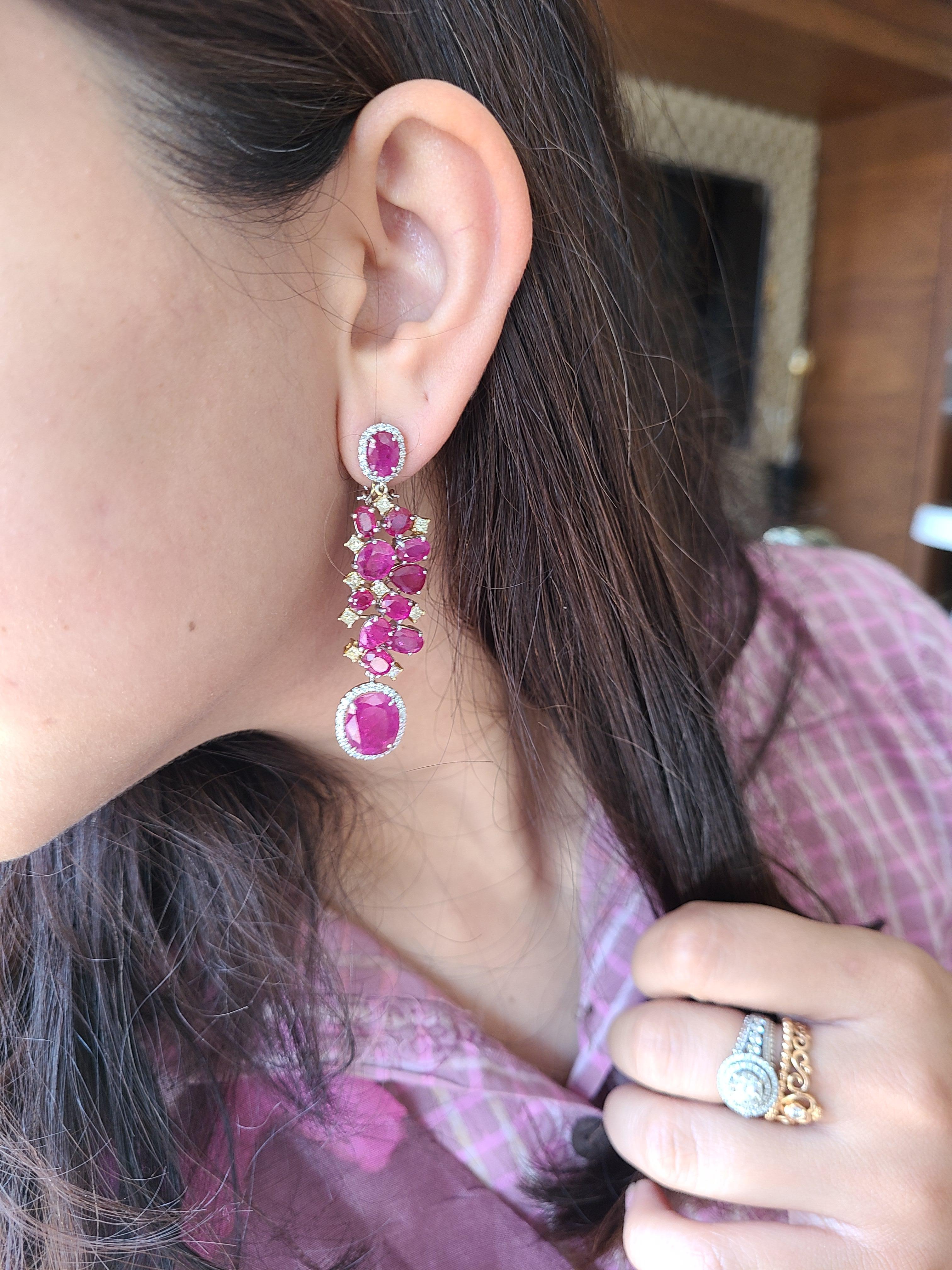 A beautiful long earrings set in 18k white and yellow gold with natural un-heat ruby and natural diamonds. The natural ruby originates from Mozambique with combined ruby weight of 24.51 carats and combined diamond weight of 1.81 carats. The net gold