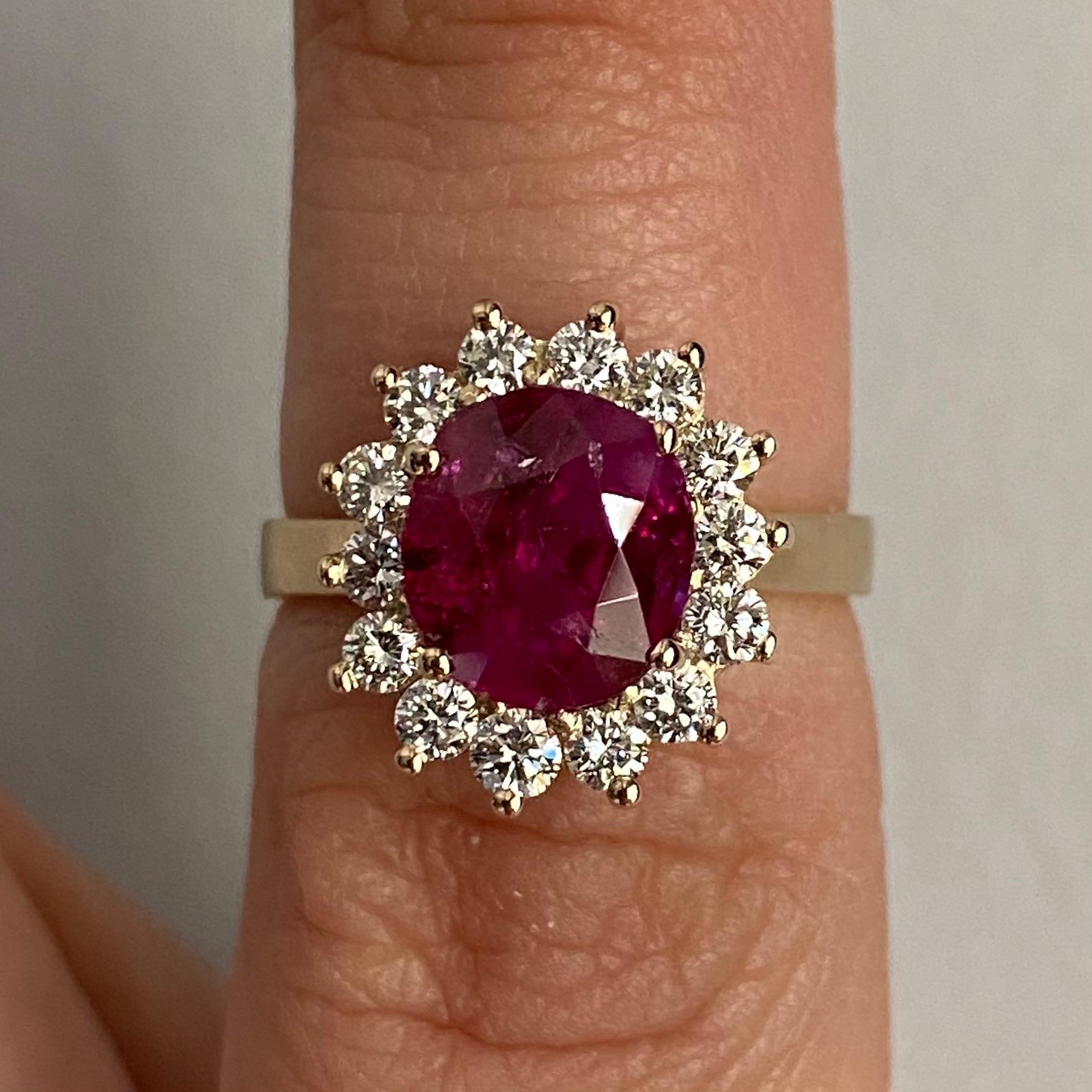 Contemporary Natural Unheated Burmese Ruby and Diamond Cluster Engagement Ring in 19.2K Yellow Gold, Portuguese, circa 2020. A charming “Lady Di” engagement ring featuring a dazzling natural unenhanced Burmese ruby claw-set to the centre, encircled