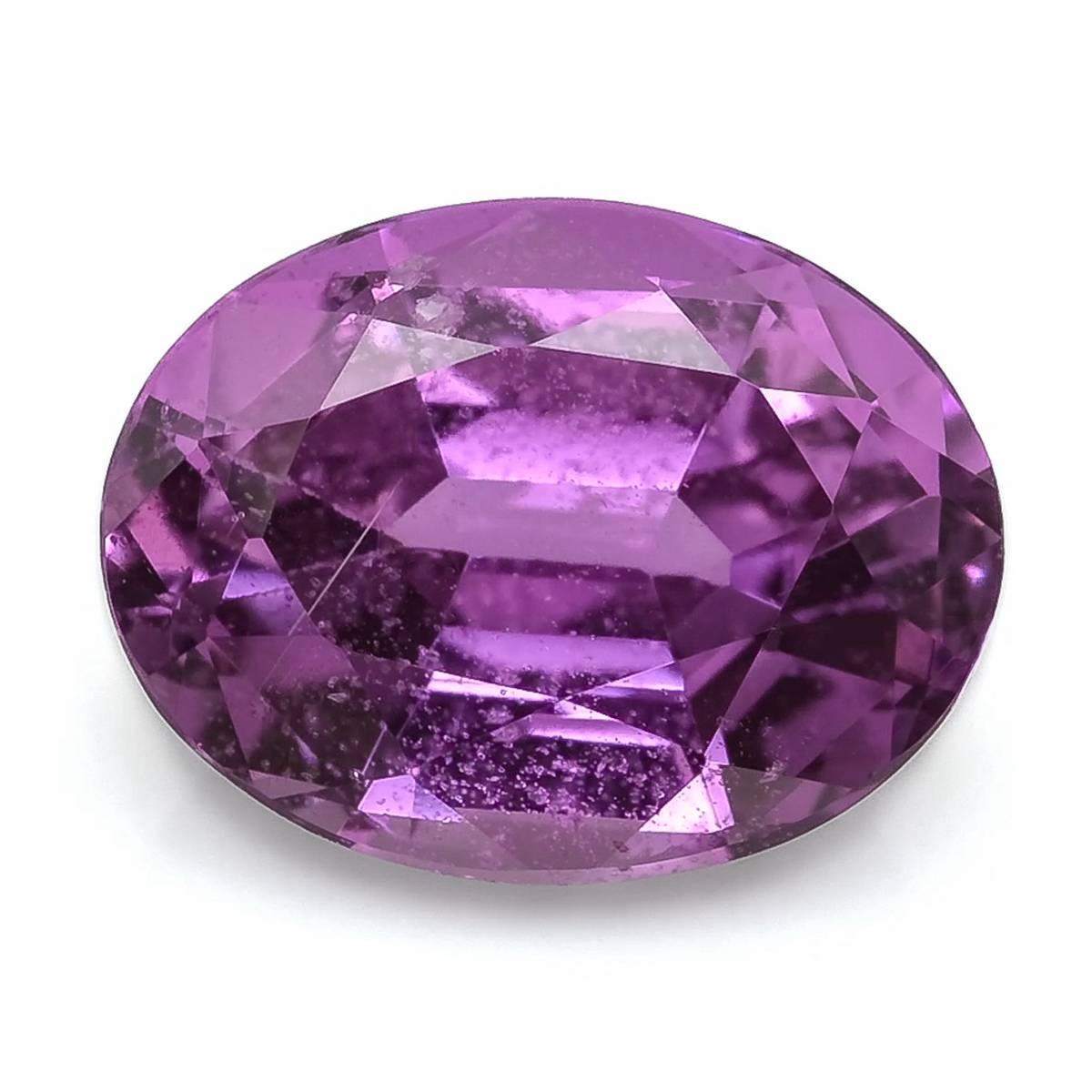 This 1.85-carat natural sapphire glows with a refined purplish-pink hue, offering both delicacy and vibrancy in one gem. Expertly cut in an oval shape with brilliant/step faceting, it maximizes sparkle while showcasing excellent symmetry and