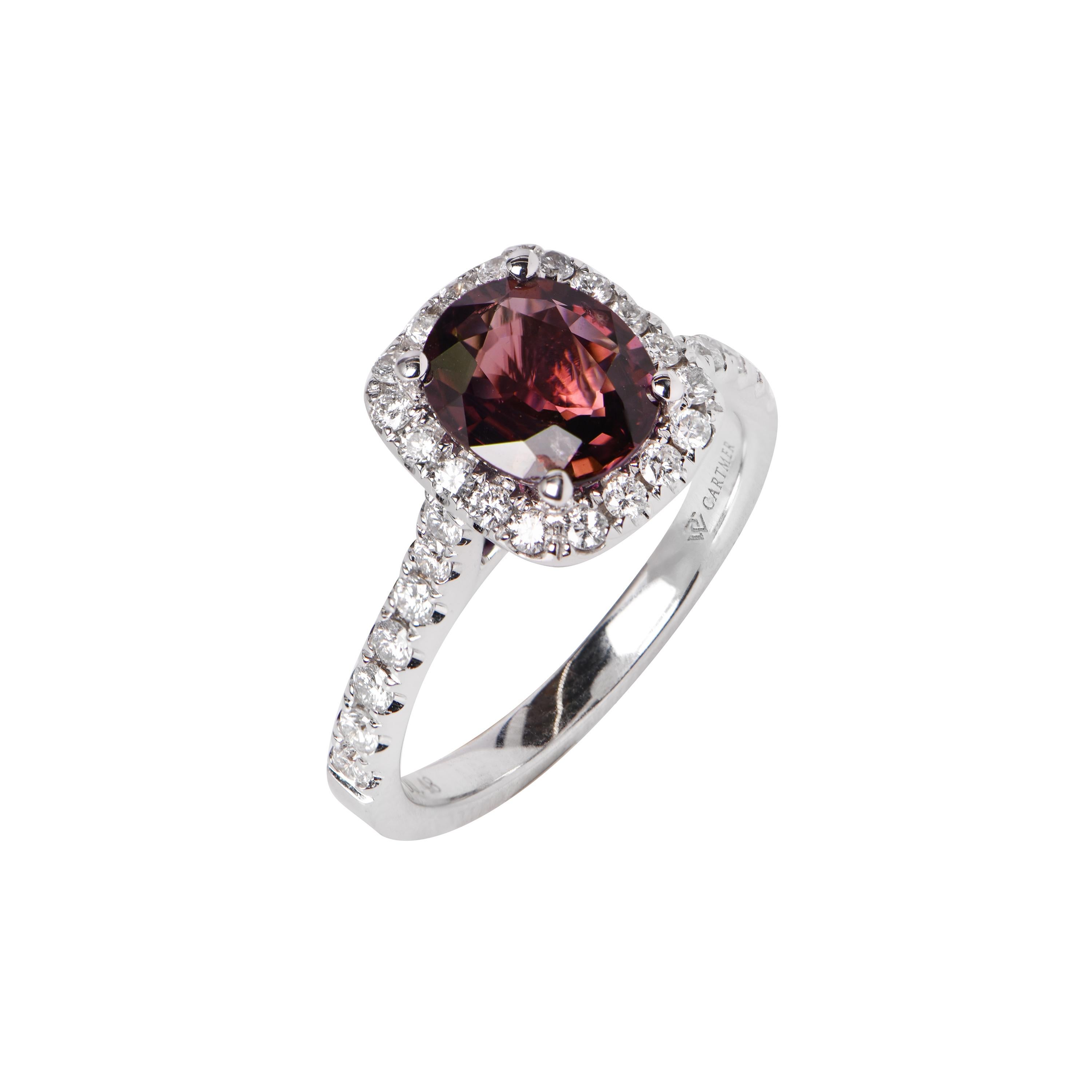 An 18ct White Gold ring showcasing a Purplish Red Natural Unheated Ruby (1.77ct) surrounded by a Halo of 32 Diamonds, totalling 0.48ct. This ring comes with a valuation certificate. Item No. 1333057.