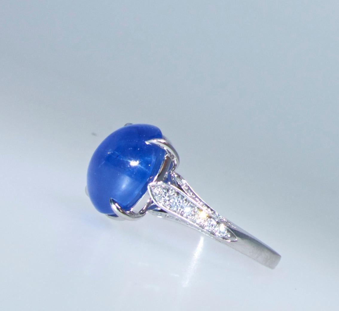 The bright blue sapphire weighs 7.86 cts. and is accented with 32 slightly graduated fine white brilliant cut diamonds.  The Sapphire, displaying a fine star, is probably Ceylon and is an unheated sapphire. The diamonds are all well matched, well