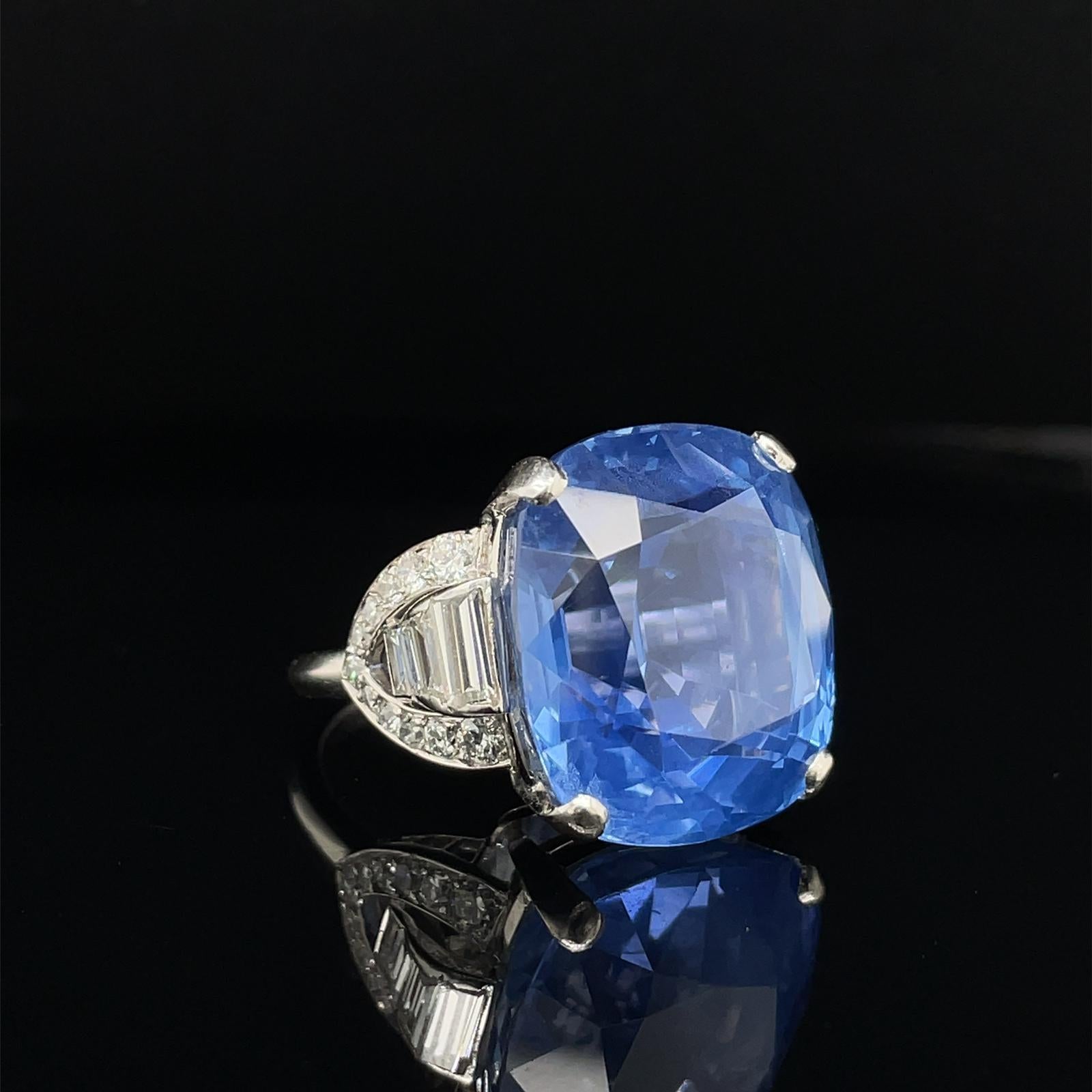 A natural untreated 31.74 carat sapphire and diamond ring in platinum, circa 1950.

The truly stunning ring is set to its centre with an impressive natural, untreated 31.74 carat cushion cut sapphire which is securely four-claw set in platinum. The