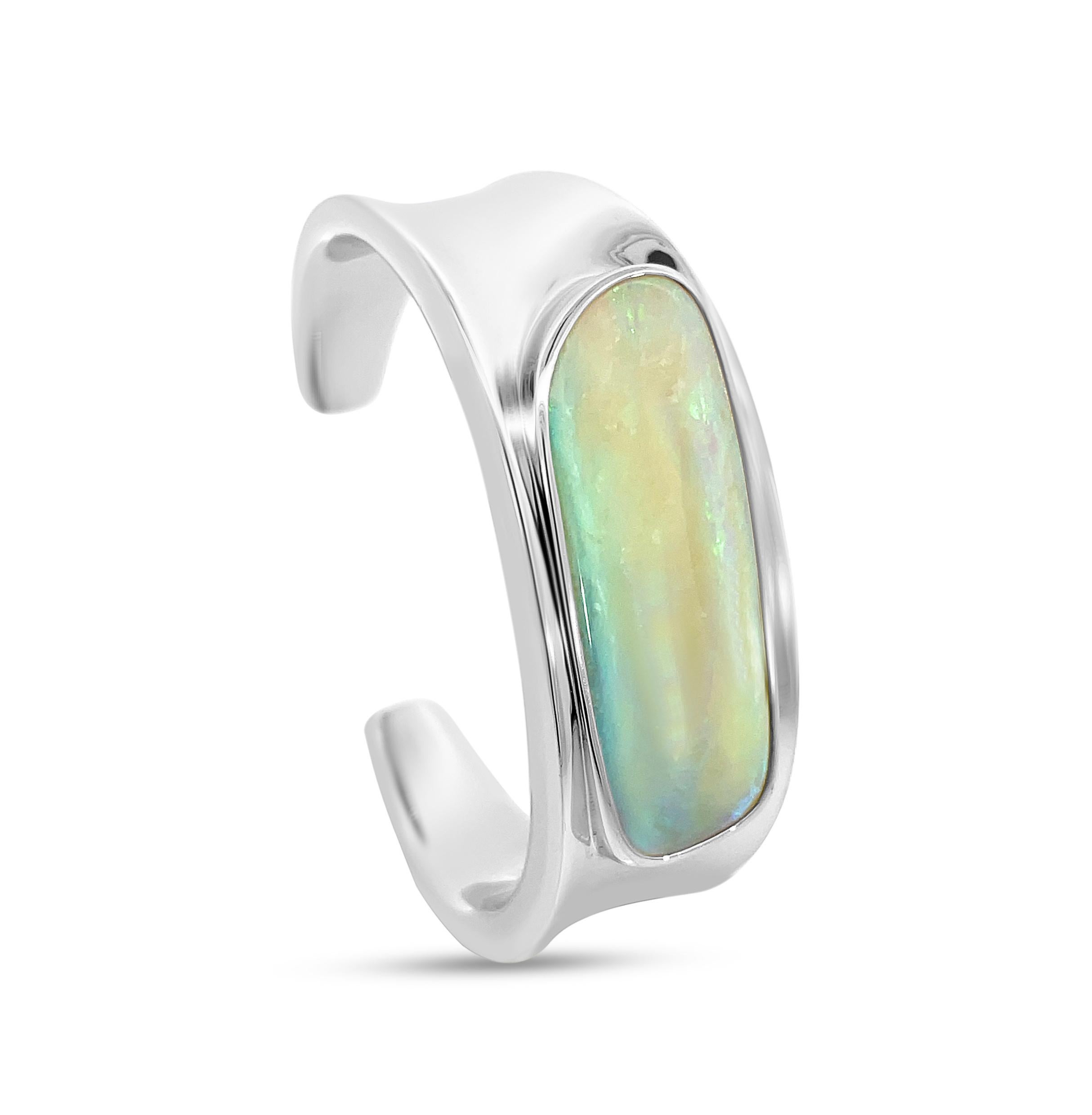 The captivating “Aurora Whisper” opal bangle bracelet, adorned with an exquisite 43.77ct boulder opal sourced directly from our own mine in Jundah, Queensland, Australia. Expertly crafted, this luminous piece showcases striking pastel hues,