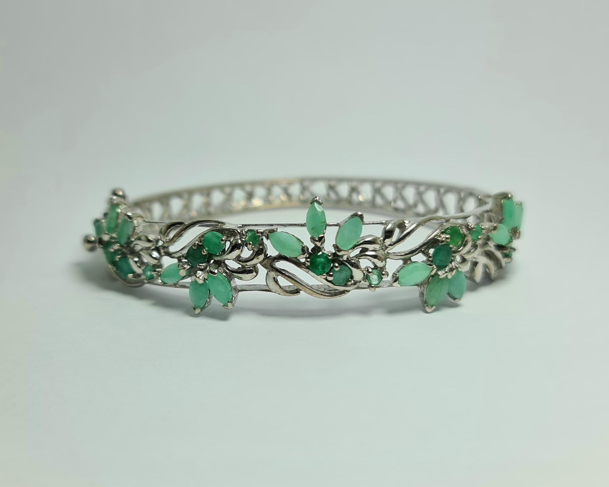 Natural Untreated Afghan Emeralds, Marquise and Rounds  cuts set in Pure .925 Sterling Silver with Rhodium Plating Hinged Bangle Bracelet Cuff

Total carat weight: 14 carats
Total weight of the bracelet: 27 grams