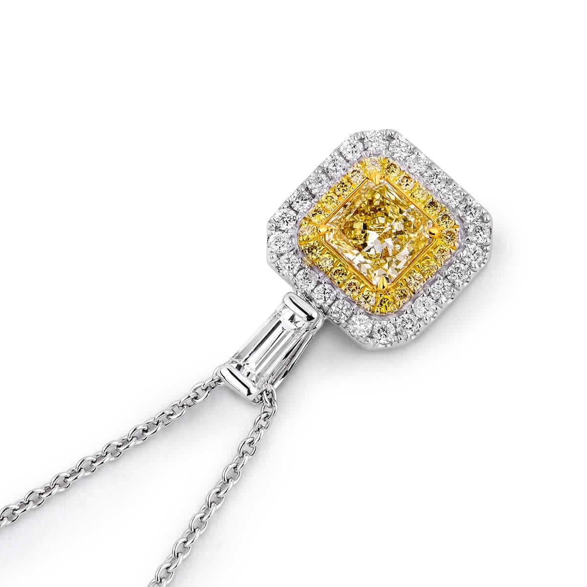 This sophisticated piece is made up of a natural untreated fancy yellow 0.57 carat diamond surrounded by smaller white and yellow diamonds making up a total carat weight of 1.11 carat. This piece has been expertly crafted using 18 karat white gold.