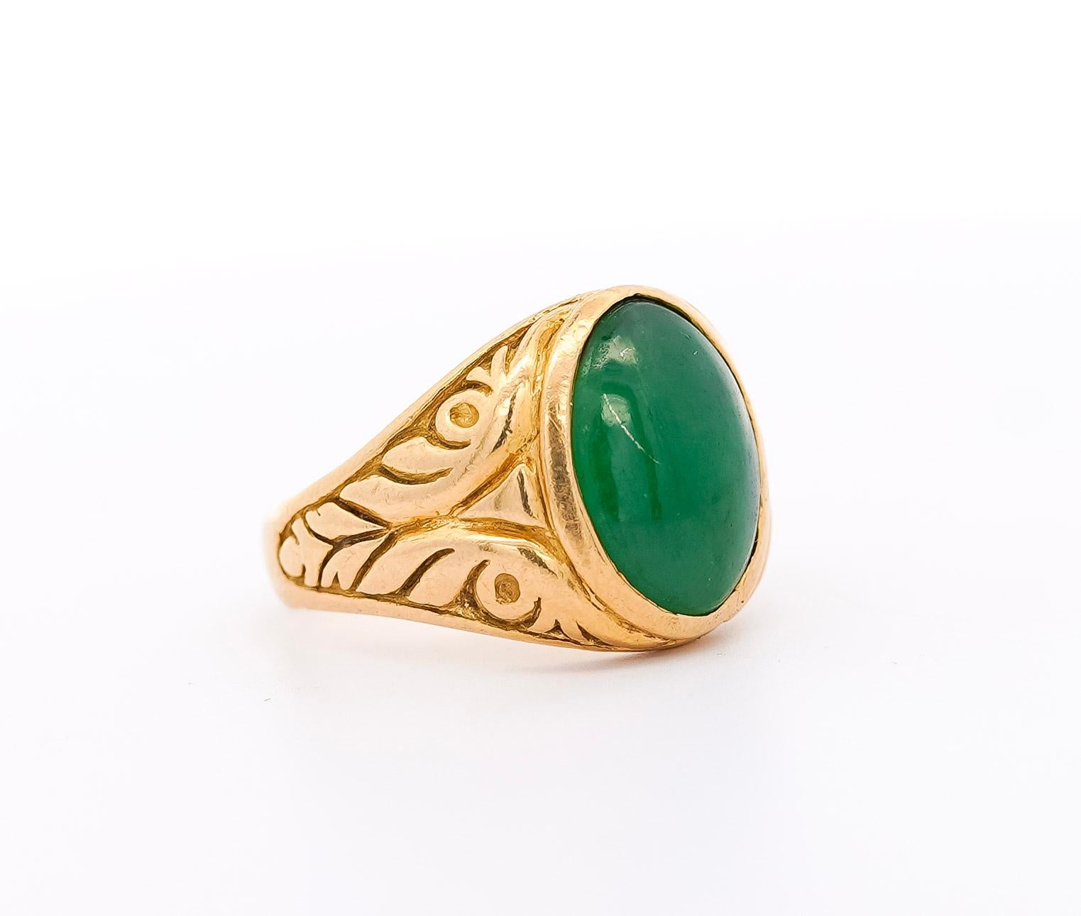 Natural Grade A Jadeite Jade solitaire ring in a 22k carved gold bezel setting. Centering a natural Jadeite Jade, known as 
