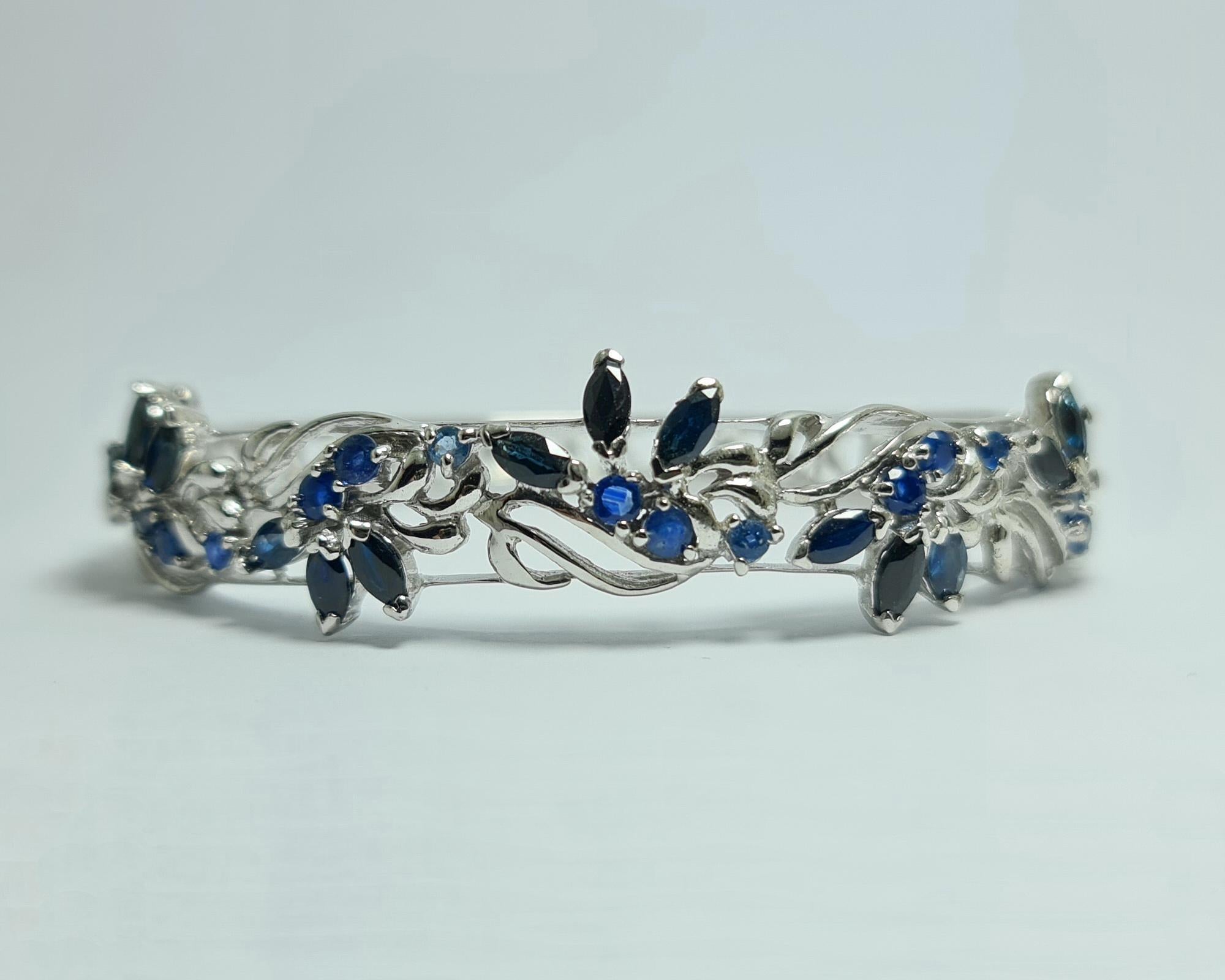 Natural Untreated Royal Blue Sapphire of Thailand origin set in Pure .925 Sterling Silver Rhodium Plated Hinged Bangle Bracelet Cuff

Total carats weight: 15 carats
Total weight of the bracelet: 26 grams