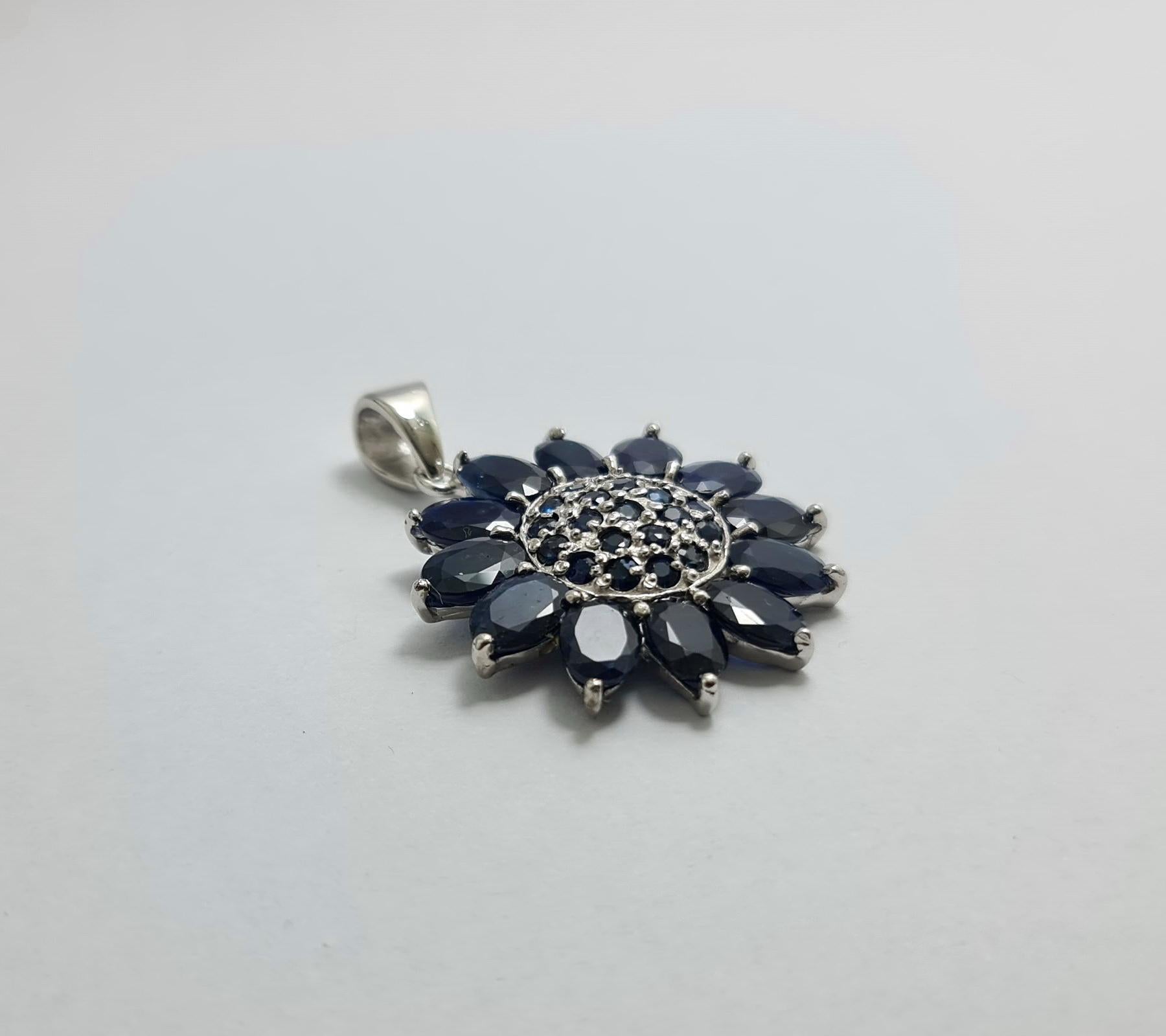 Natural Untreated Unheated Thailand Sapphires  Sunflower Pendant set in Pure .925 Sterling Silver with Rhodium Plating 

Total weight of Sapphires: 12 carats
Total weight of the pendant is 8.7 grams

Please check other listings for matching sets 