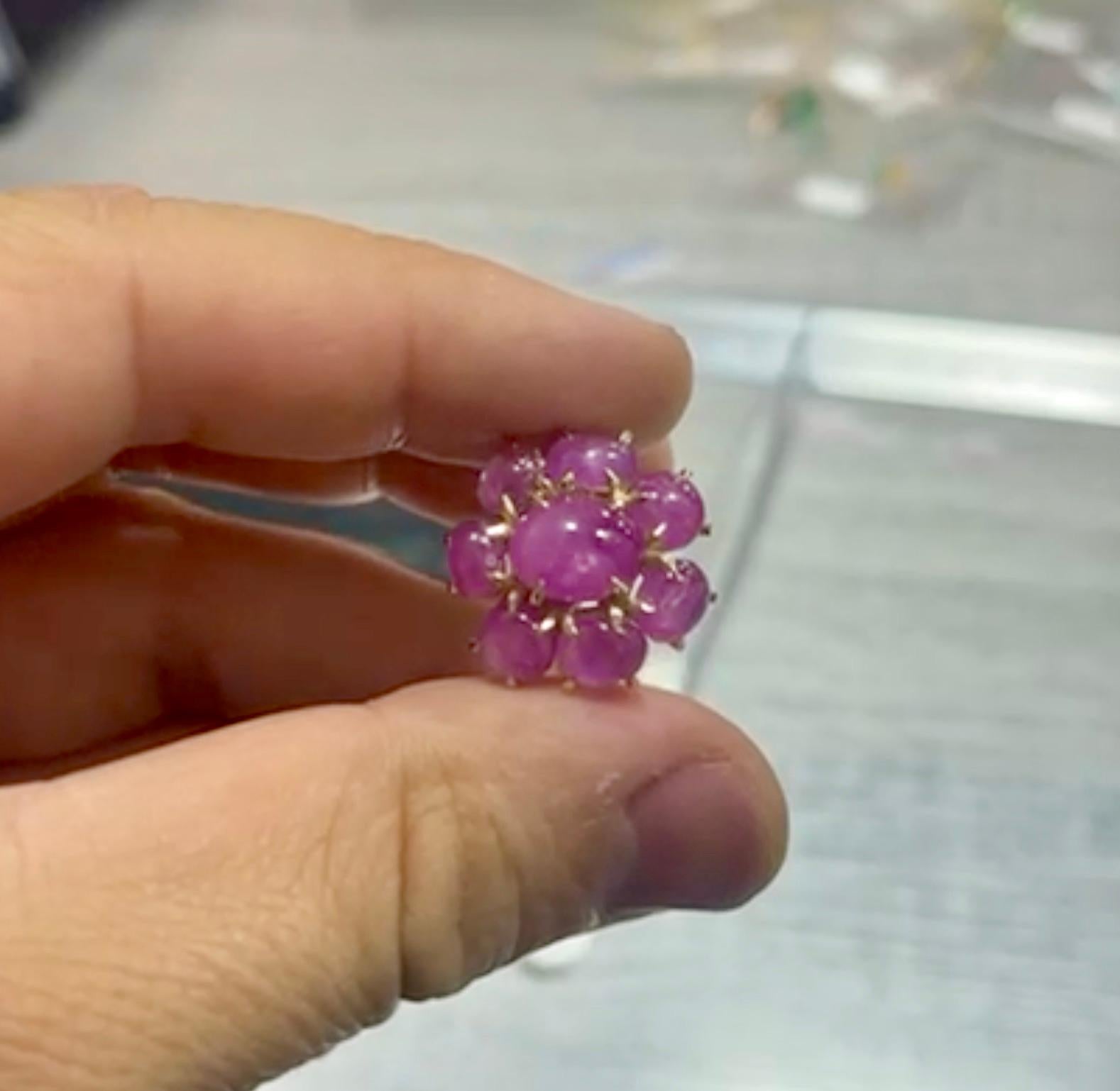 An exquisite cocktail ring, featuring in the center a 4.0 carat natural star ruby as having a Burma origin with a pinkish-red color and indicates no heating enhancement, set on a classic claw prong setting. Surrounded by a halo of seven Burmese
