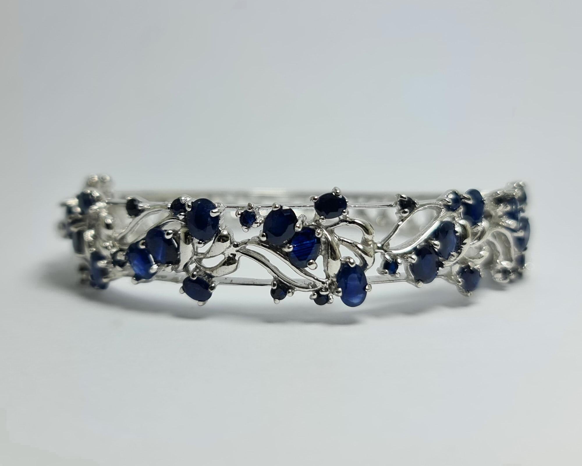 Natural Untreated Blue Sapphire Thailand Origin,set in Pure .925 Sterling Silver with Rhodium Plating on this beautiful  Hinged Bangle Cuff Bracelet 

Carats weight : 14 carats
Total weight of the bracelet : 27 grams