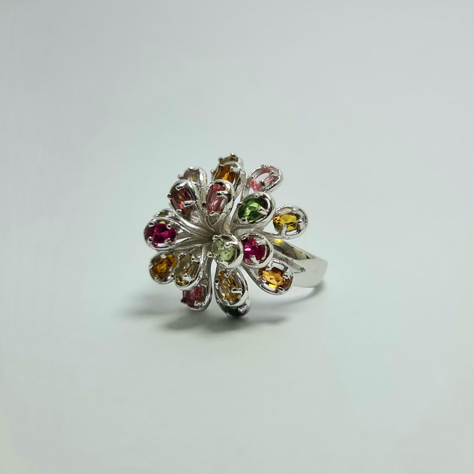 Natural Untreated Brazilian Multi coloured Tourmaline Firework Burst design 
Pure .925 Sterling Silver Rhodium Plated Ring  All sizes available at no cost per request 

Weight of the Tourmaline: 7 carats
Total weight of the ring: 12 grams