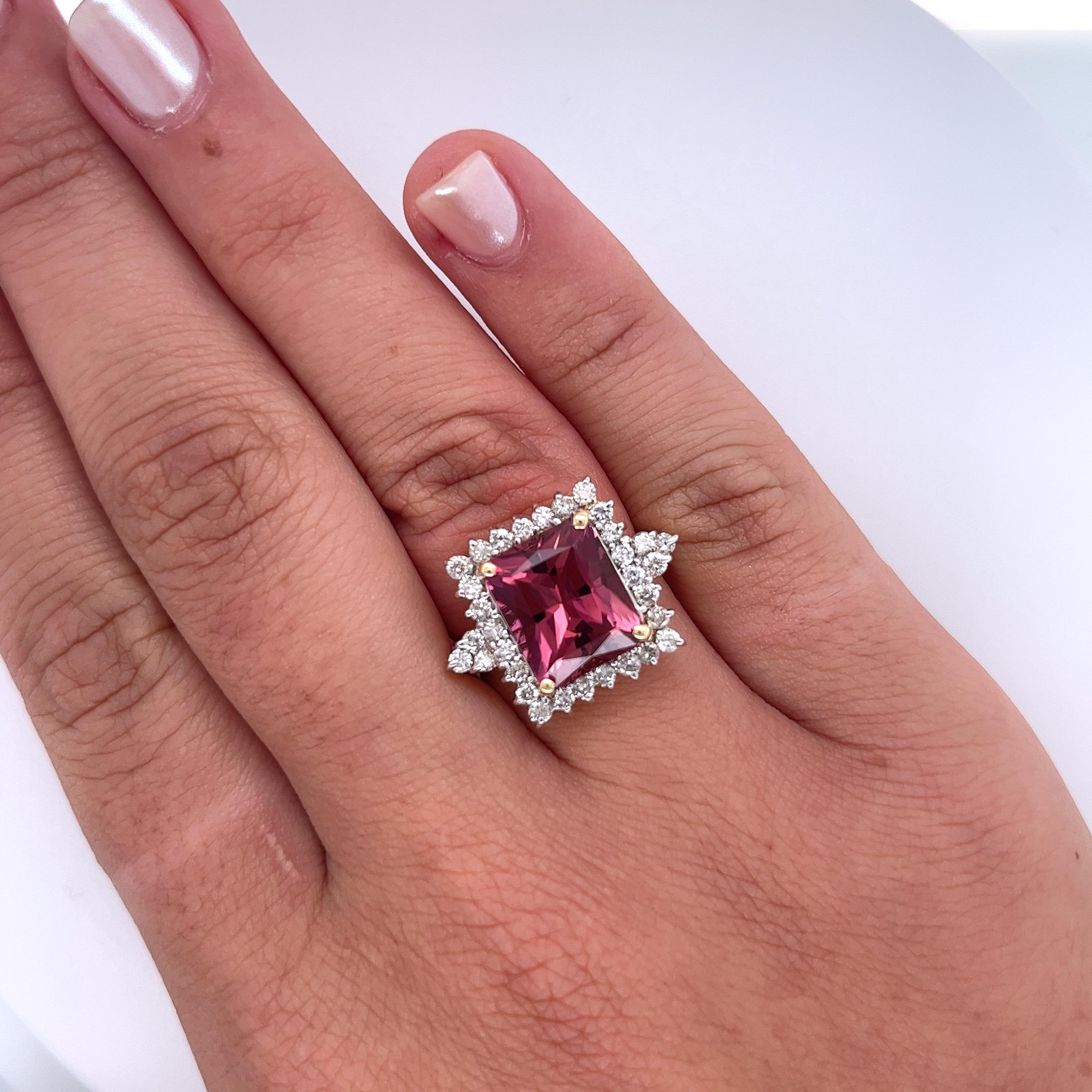 Vintage 7 Carat Pink Tourmaline and 1 Carat Diamond Ring. Centering a richly saturated vivid pink radiant cut tourmaline of excellent color and clarity. Adorned with a round cut diamond halo of eye-clean clarity. The shank thins out as it reaches