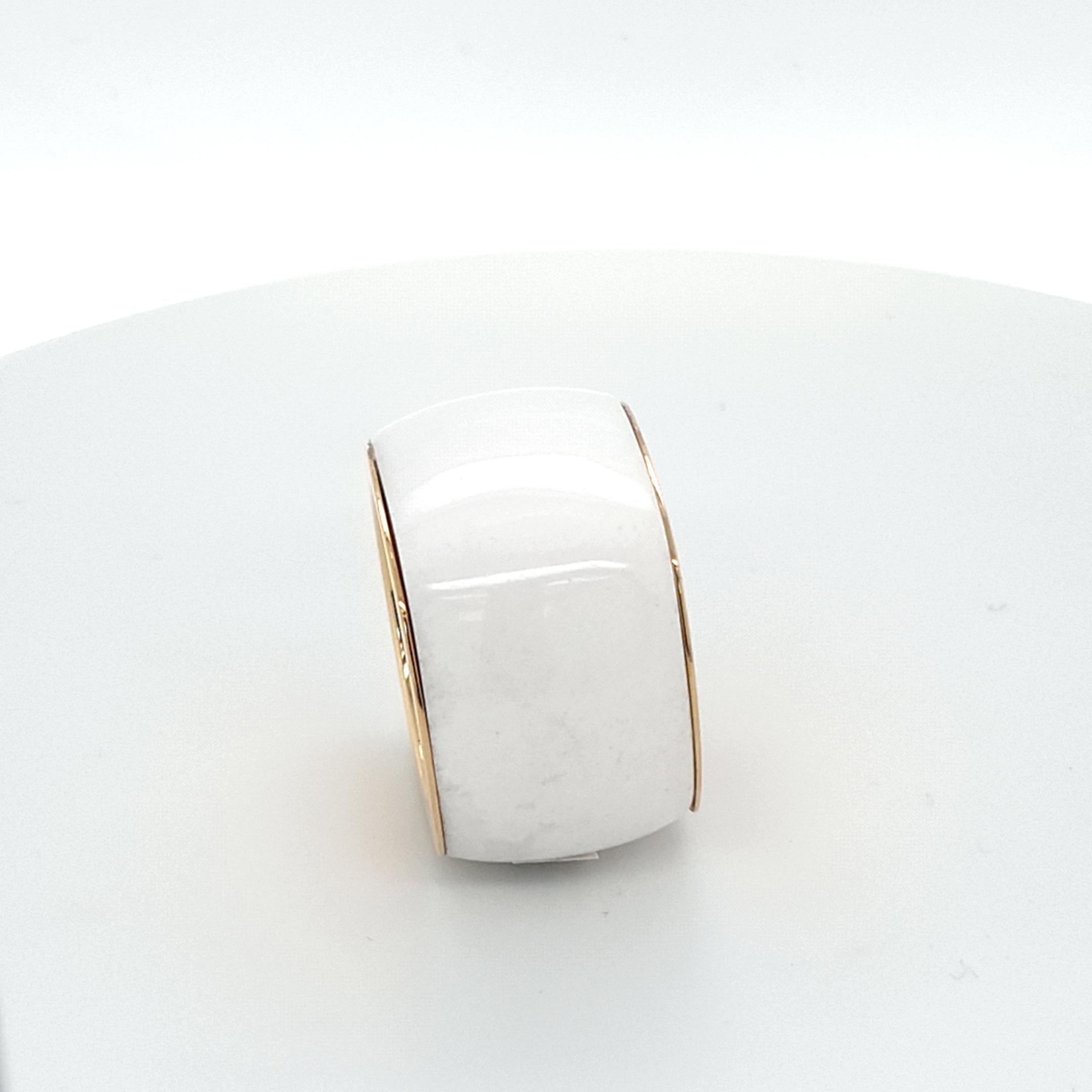 This Natural White Agate Ring with 18 Carat Yellow Gold is totally handmade.
Cutting as well as goldwork are made in German quality. 
Finding a suitable nice Natural White Agate to cut a whole ring out of one piece is very difficult.
The cushion