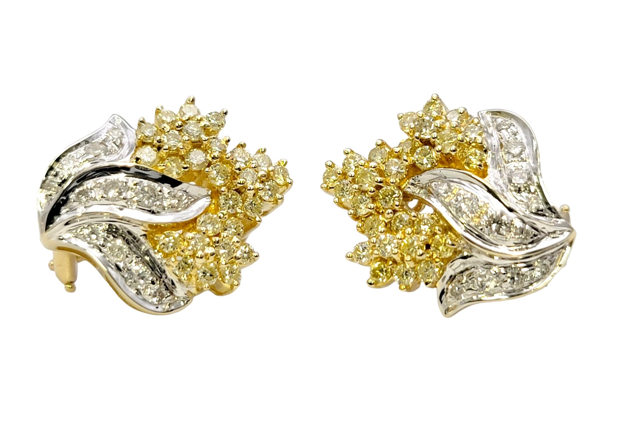 These super sparkly diamond cluster earrings absolutely glow. The elegant two toned design pops beautifully on the lobe, giving a chic and glamorous look. 

These beautiful earrings each feature shimmering clusters of white and fancy light yellow